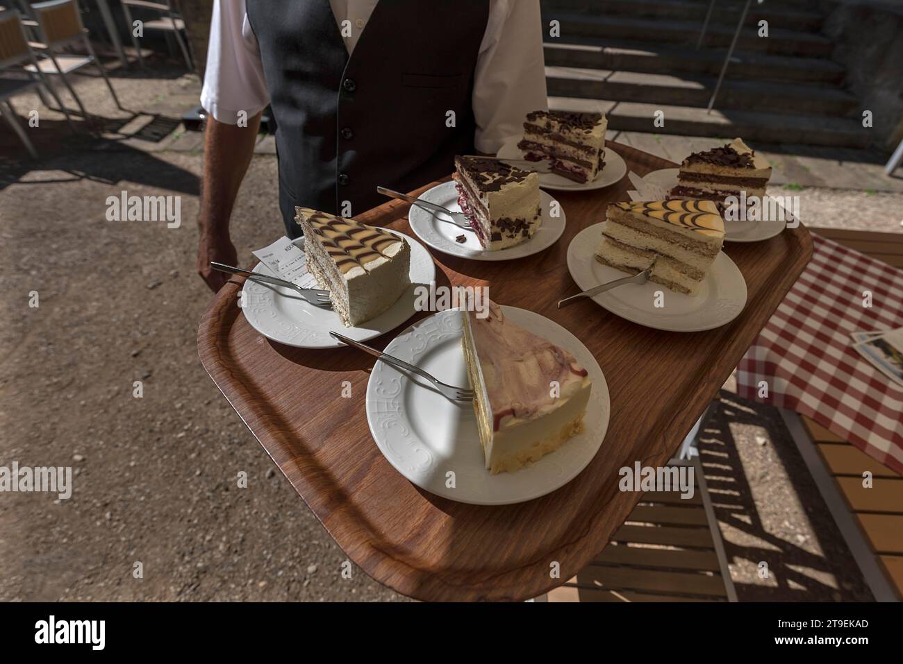 Waitress brings various pieces of cake on a tray to the guests, Bavaria, Germany Stock Photo