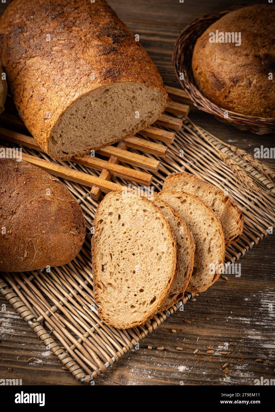 Slices of baked bread, sourdough bread on wooden background Stock Photo