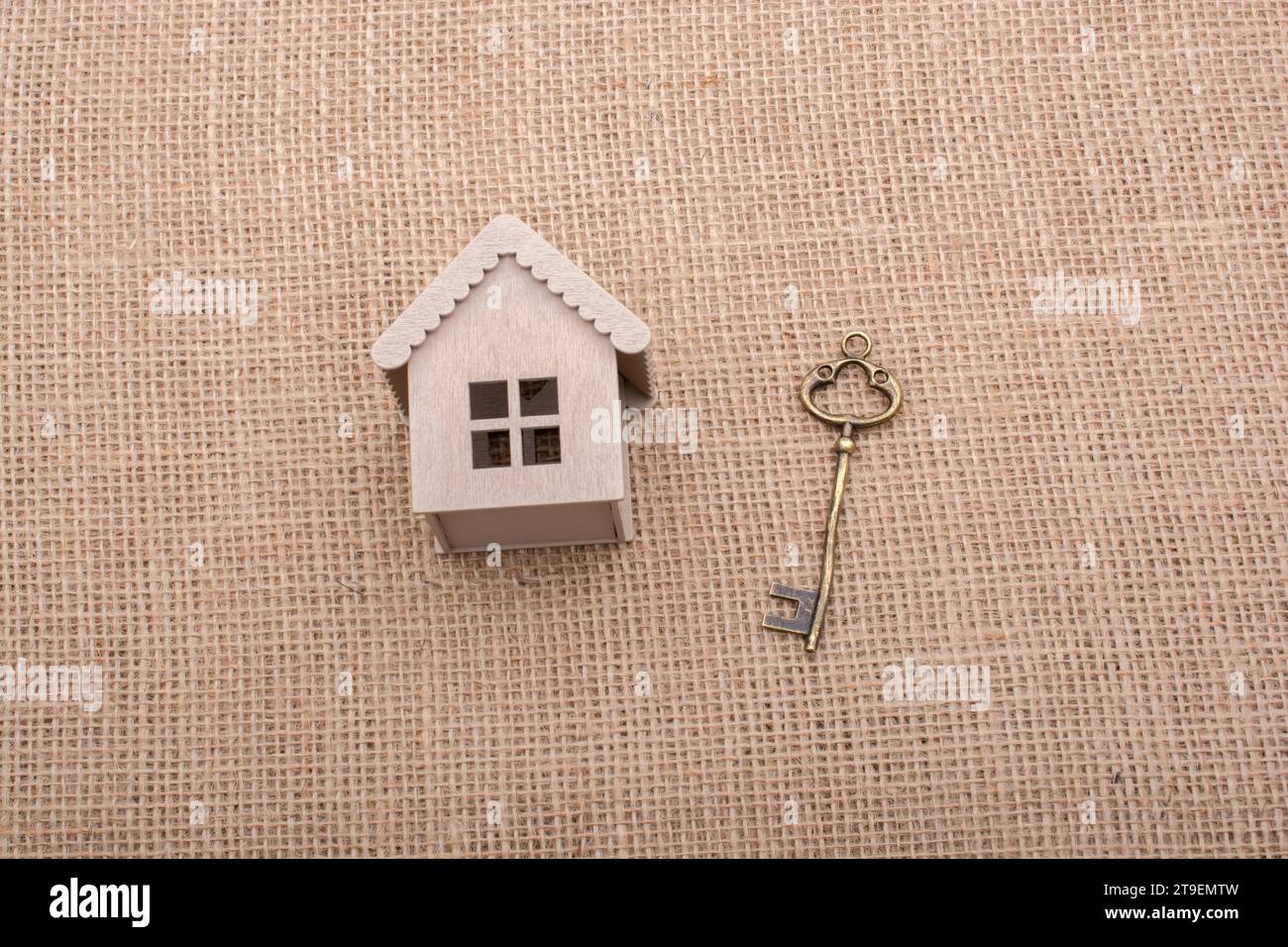 Retro key and a Model house on a canvas background Stock Photo - Alamy