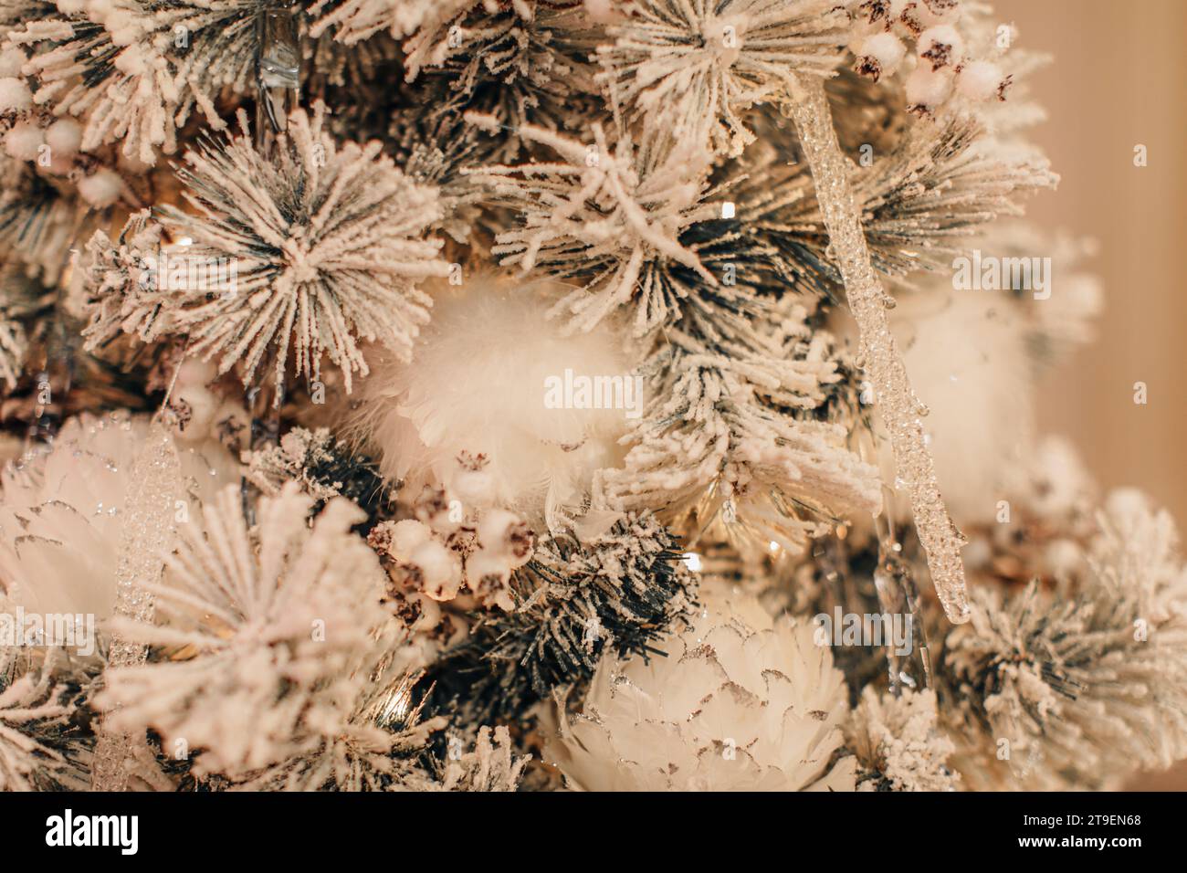 White Christmas background, snow covered Christmas tree branches, decorated with snowflakes. Festive details Stock Photo