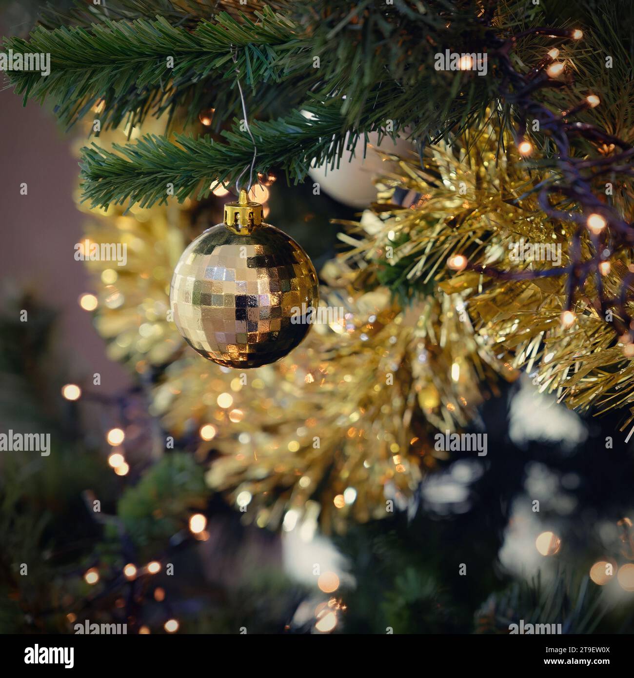 Christmas background. Beautiful colorful decorations on the Christmas tree with lights. Abstract concept for holidays and winter time. Stock Photo