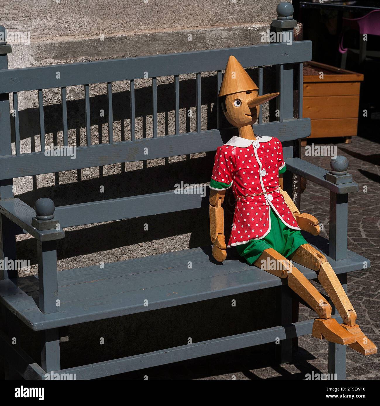 Wooden doll reminiscent of Pinocchio, with a long nose and moveable