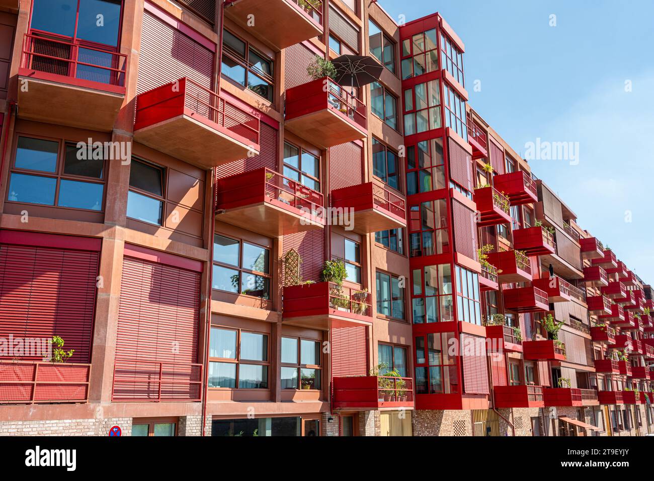 New red apartment building with balconies seen in Berlin, Germany Stock Photo