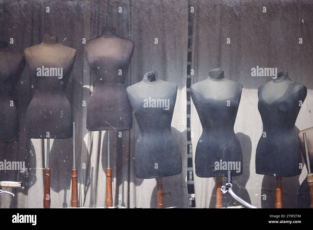 Female dress forms in a shop window (dirty) Stock Photo