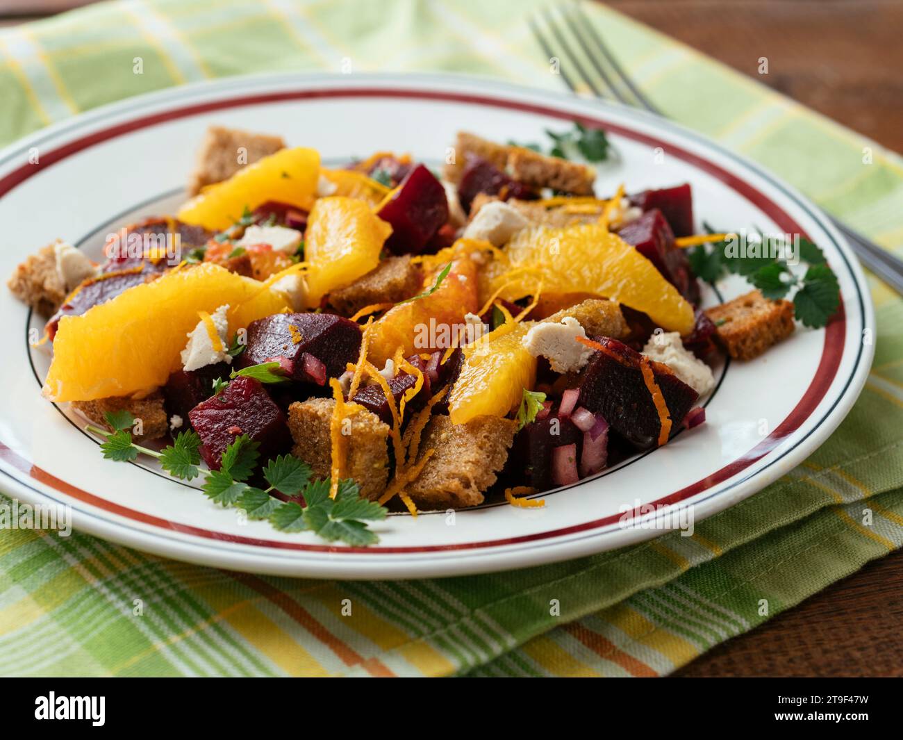 Beet and rye bread panzanella with oranges and home made vegan feta Stock Photo