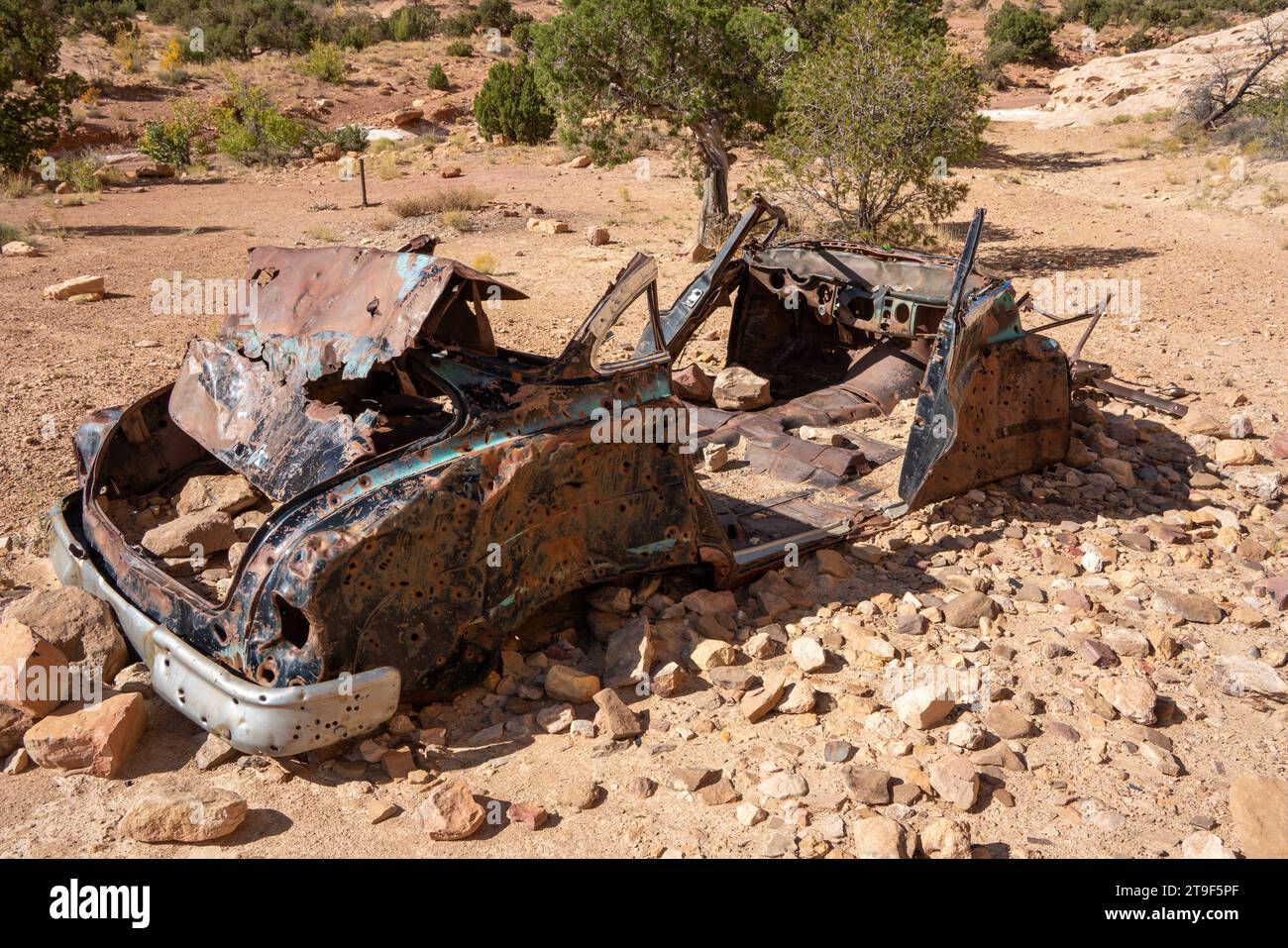 Abandoned mid century car with many bullet holes in desert Stock Photo ...