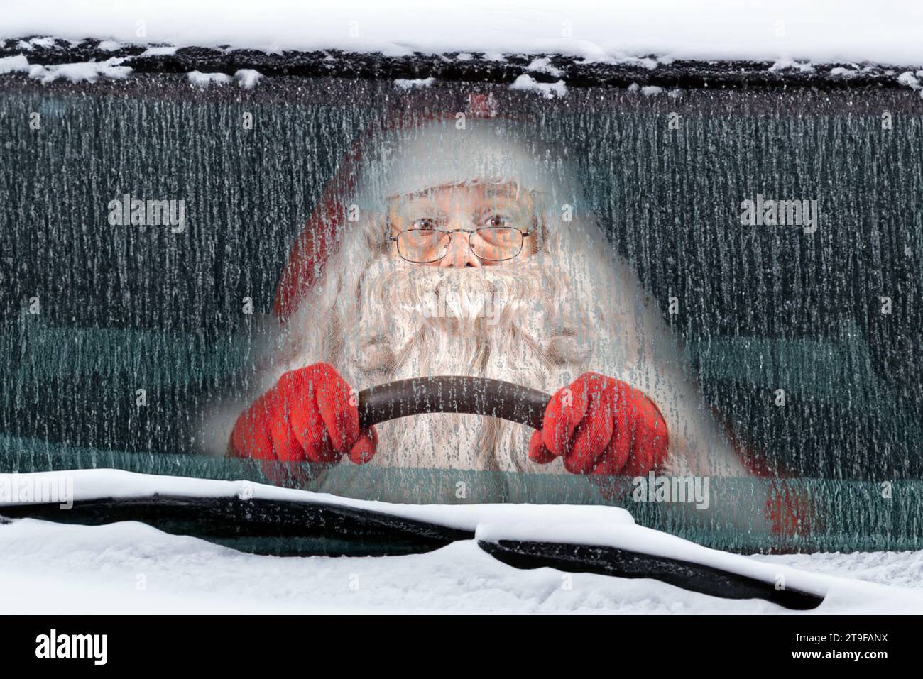 Santa Claus drives a snowy car Stock Photo