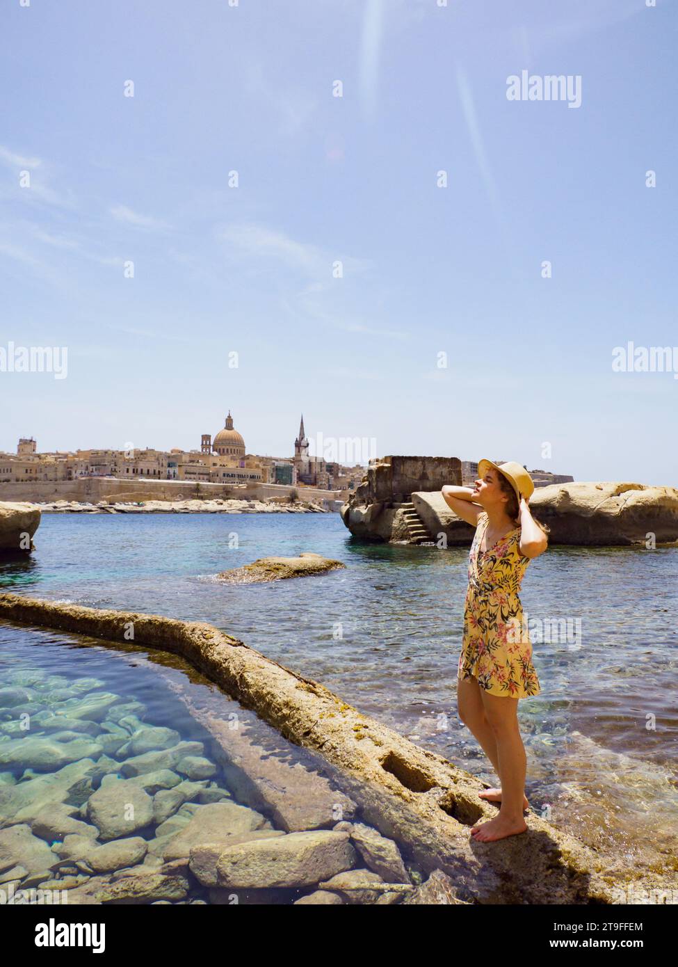 Tourist on the a rocky coast with coves and turquoise waters in Malta. Europe Sliema coastline in Malta, Europe. Stock Photo
