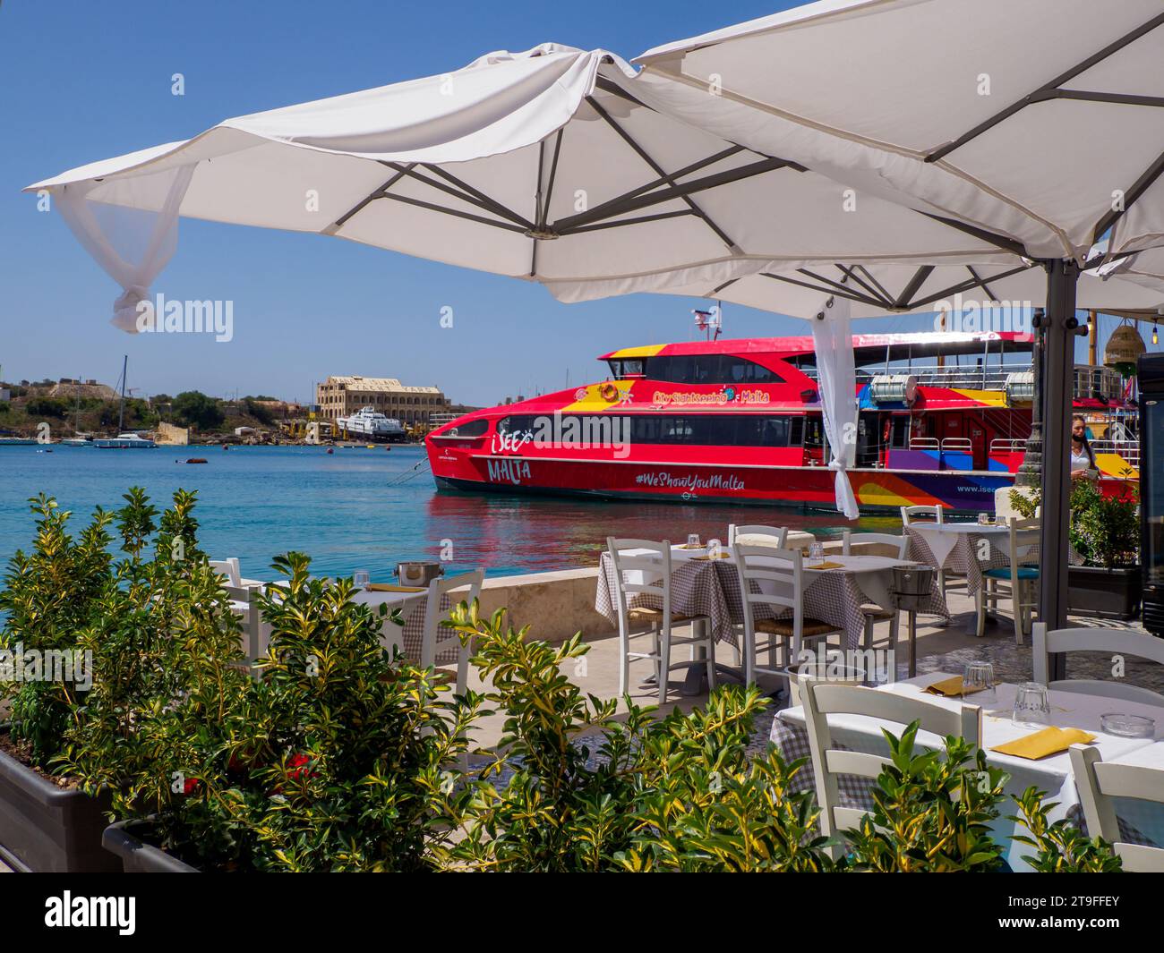 Sliema, Malta - May, 2021: Tuoristic red ship 'hop on hop off' in the port of Sliema district. Sliema Ferry port. Malta. Europe Stock Photo