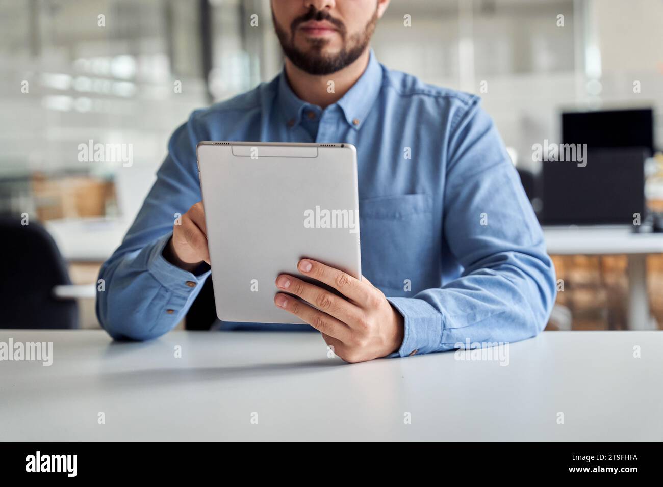 Busy young business man manager using tablet computer, close up. Stock Photo