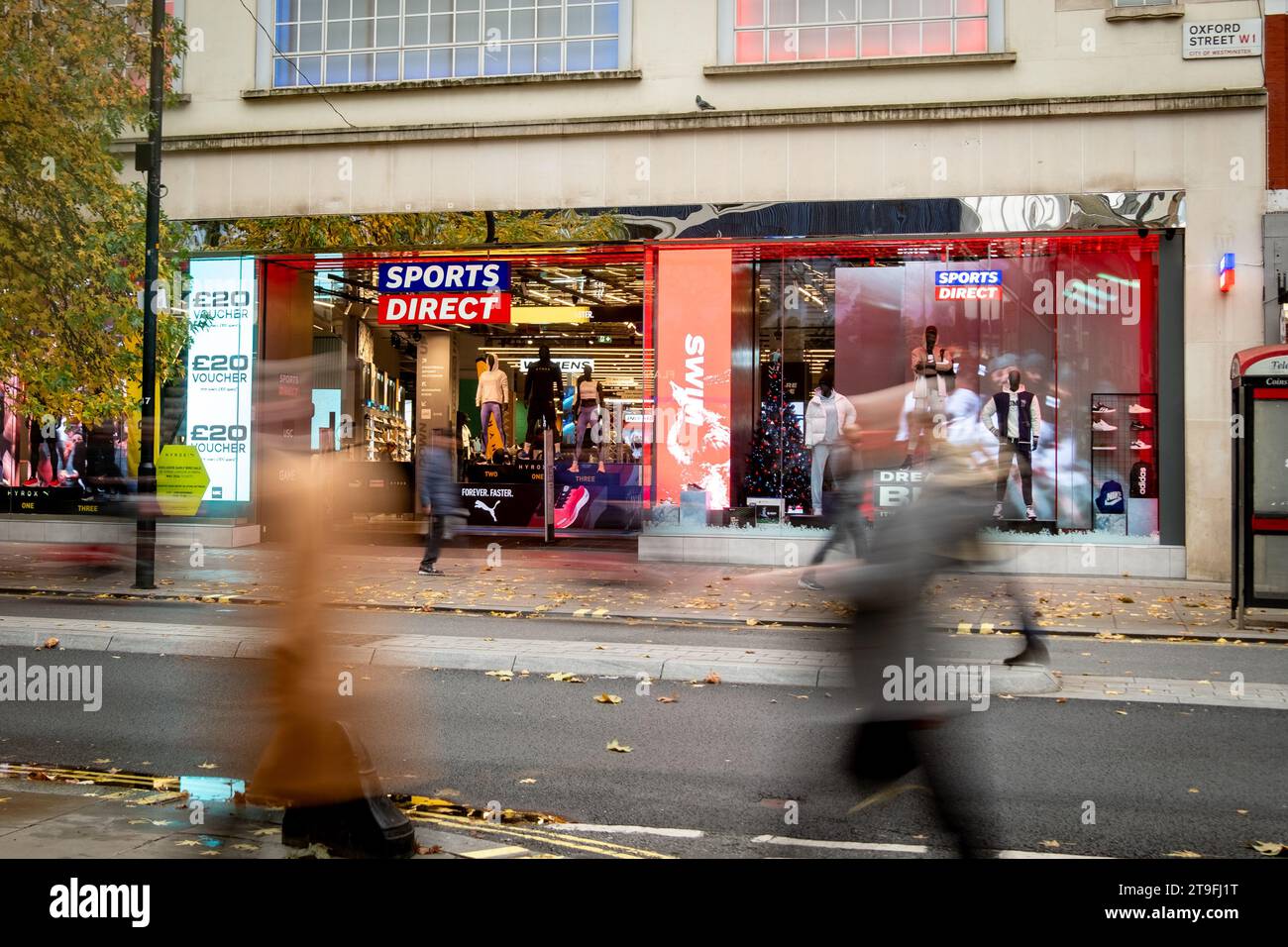 LONDON NOVEMBER 23, 2023 Sports Direct store and motion blurred shoppers on Oxford Street