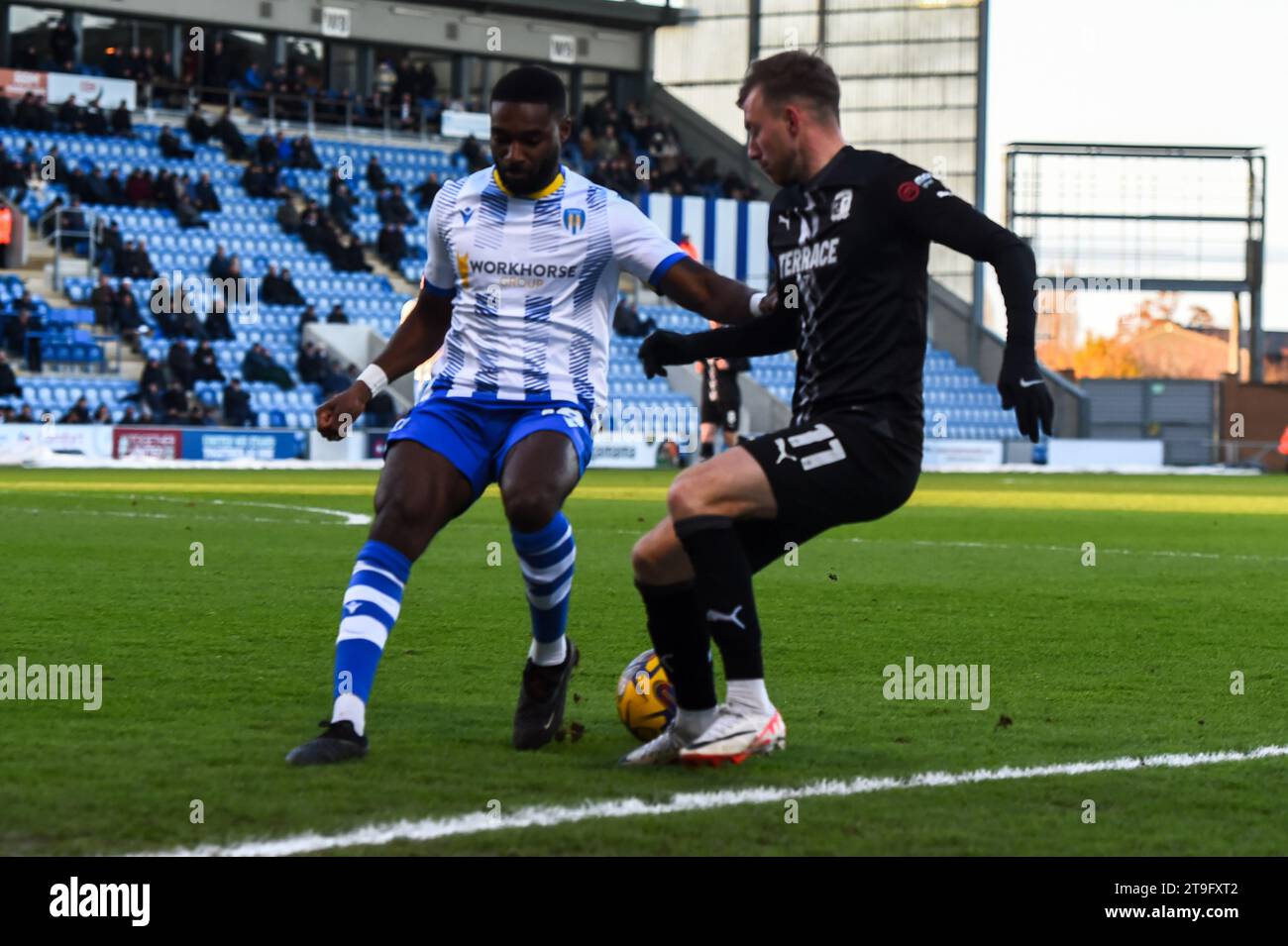 Mandela Egbo (18 Colchester United) and Elliot Newby (11 Barrow) challenge for the ball during the Sky Bet League 2 match between Colchester United and Barrow at the Weston Homes Community Stadium, Colchester on Saturday 25th November 2023. (Photo: Kevin Hodgson | MI News) Credit: MI News & Sport /Alamy Live News Stock Photo