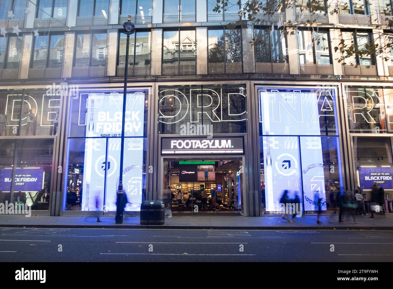 LONDON- NOVEMBER 23, 2023: Footasylum shoe shop and motion blurred shoppers on Oxford Street, landmark retail destination Stock Photo