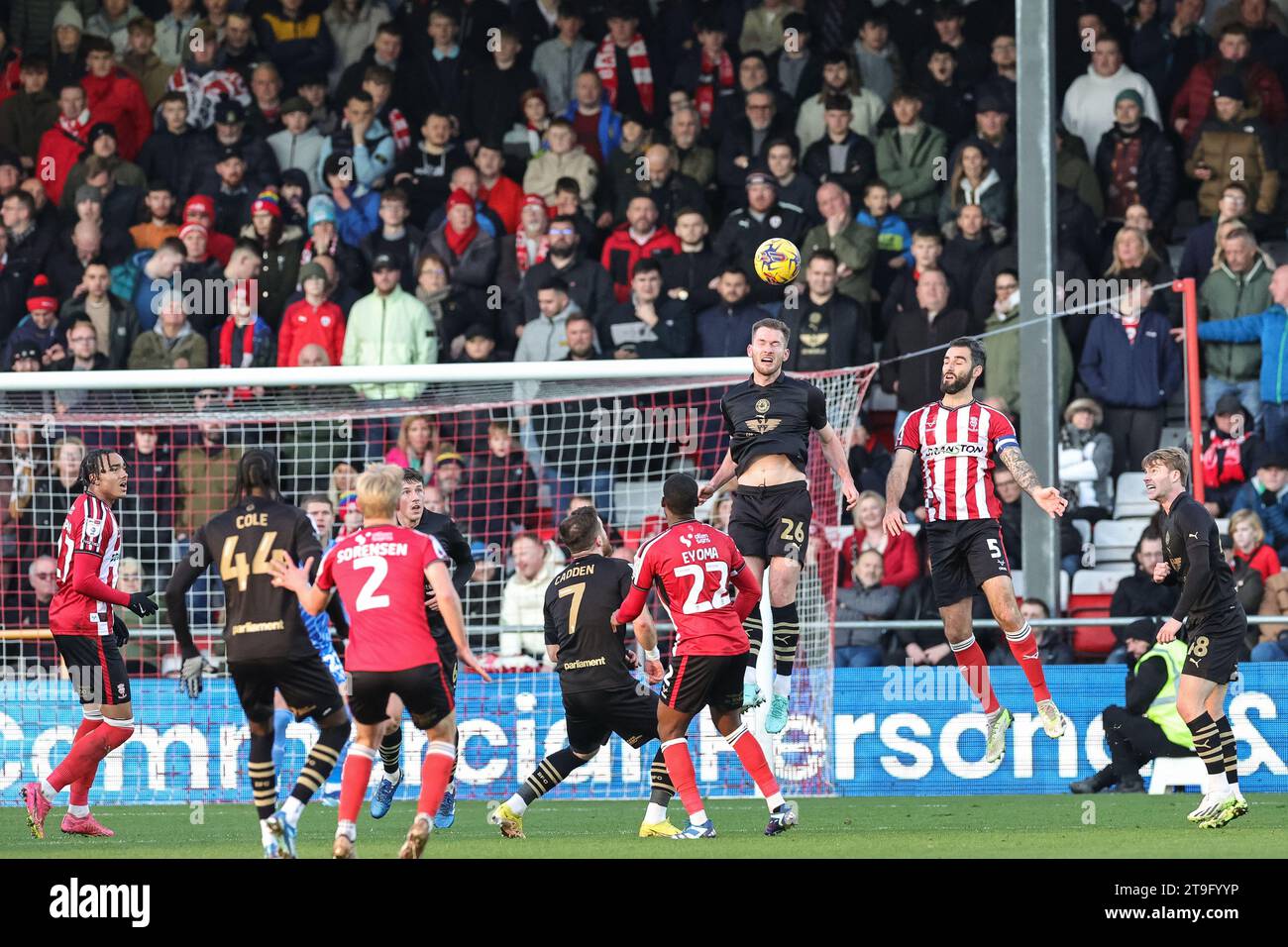 Lincoln, UK. 25th Nov, 2023. Jamie McCart #26 of Barnsley heads clear during the Sky Bet League 1 match Lincoln City vs Barnsley at Gelder Group Sincil Bank Stadium, Lincoln, United Kingdom, 25th November 2023 (Photo by Mark Cosgrove/News Images) in Lincoln, United Kingdom on 11/25/2023. (Photo by Mark Cosgrove/News Images/Sipa USA) Credit: Sipa USA/Alamy Live News Stock Photo