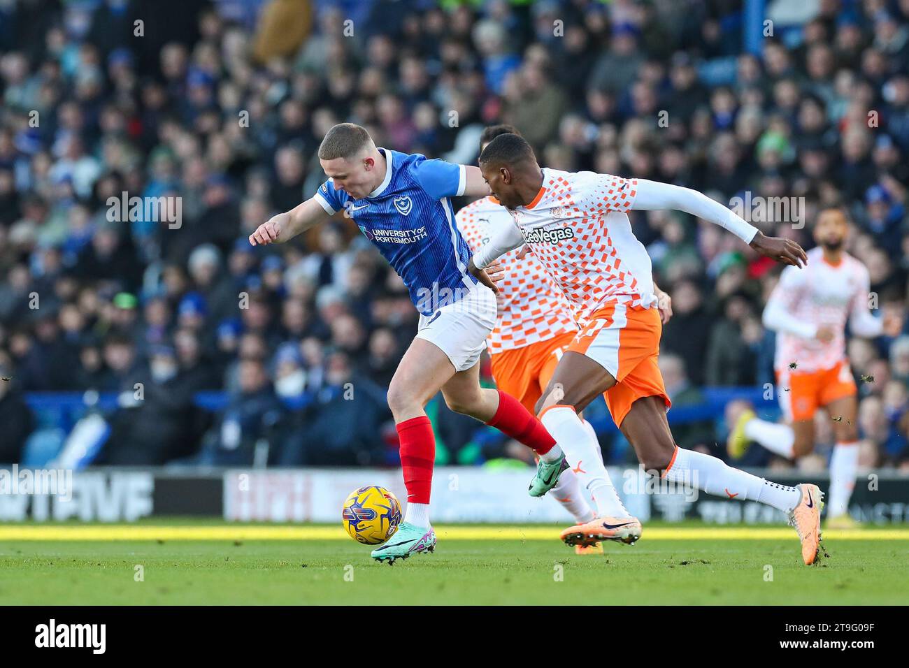 Portsmouth, UK. 25th Nov, 2023. Portsmouth forward Colby Bishop (9) battles withBlackpool midfielder Karamoko Dembele (11) during the Portsmouth FC v Blackpool FC sky bet EFL League One match at Fratton Park, Portsmouth, England, United Kingdom on 25 November 2023 Credit: Every Second Media/Alamy Live News Stock Photo