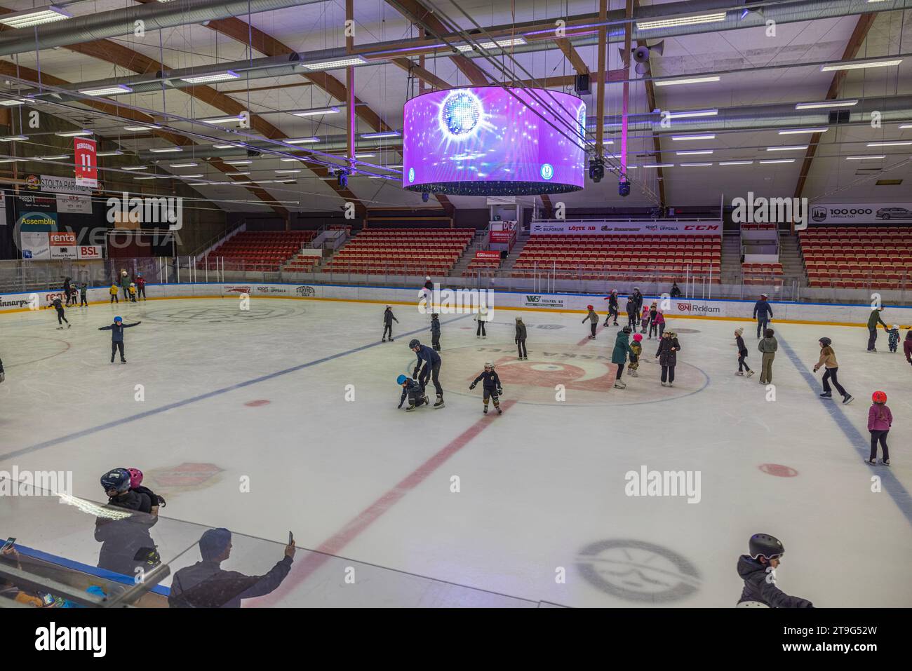 Charming sports complex with ice skating rink where both kids and adults glide gracefully. Sweden. Uppsala. Stock Photo