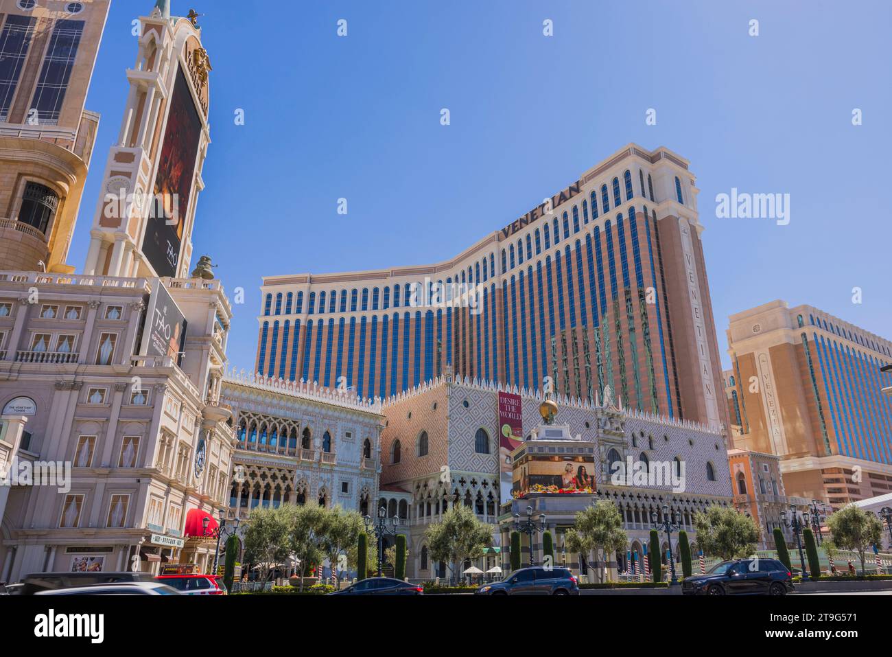 View of famous Las Vegas Strip with cars pass Venetian casino hotel on sunlit day. Las Vegas. USA. Stock Photo
