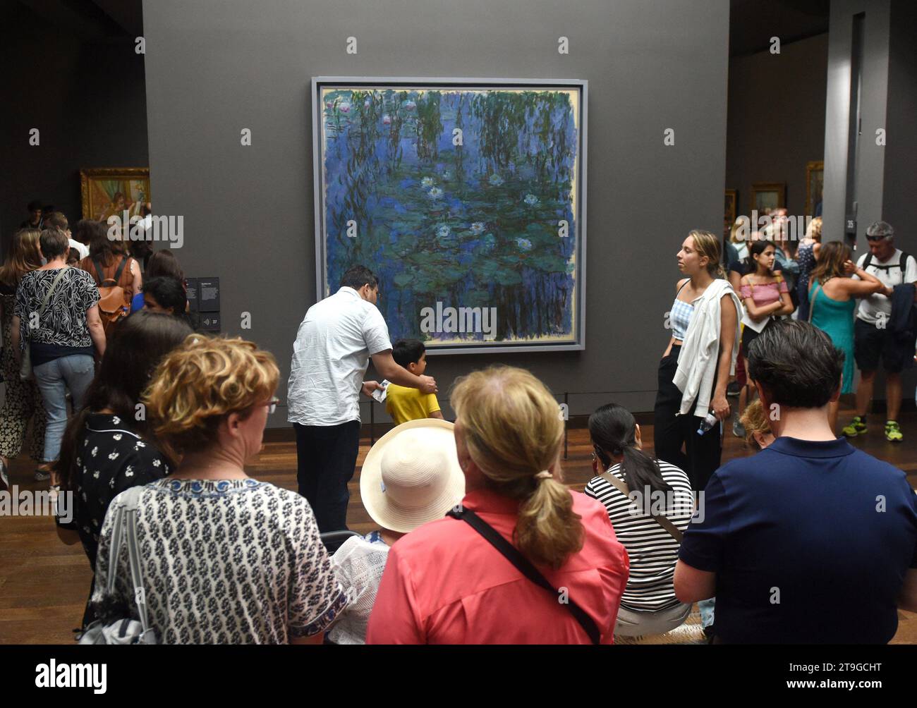 Paris, France - August 29, 2019: Crowd of visitors near the Blue Water Lilies, 1916–1919 by Claude Monet painting in Museum d'Orsay in Paris, France. Stock Photo