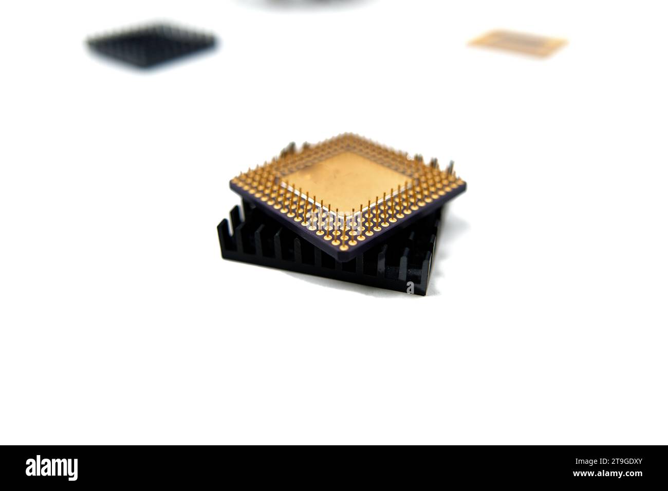 Microprocessor with a heat sink lying on a white surface, isolated on white Stock Photo