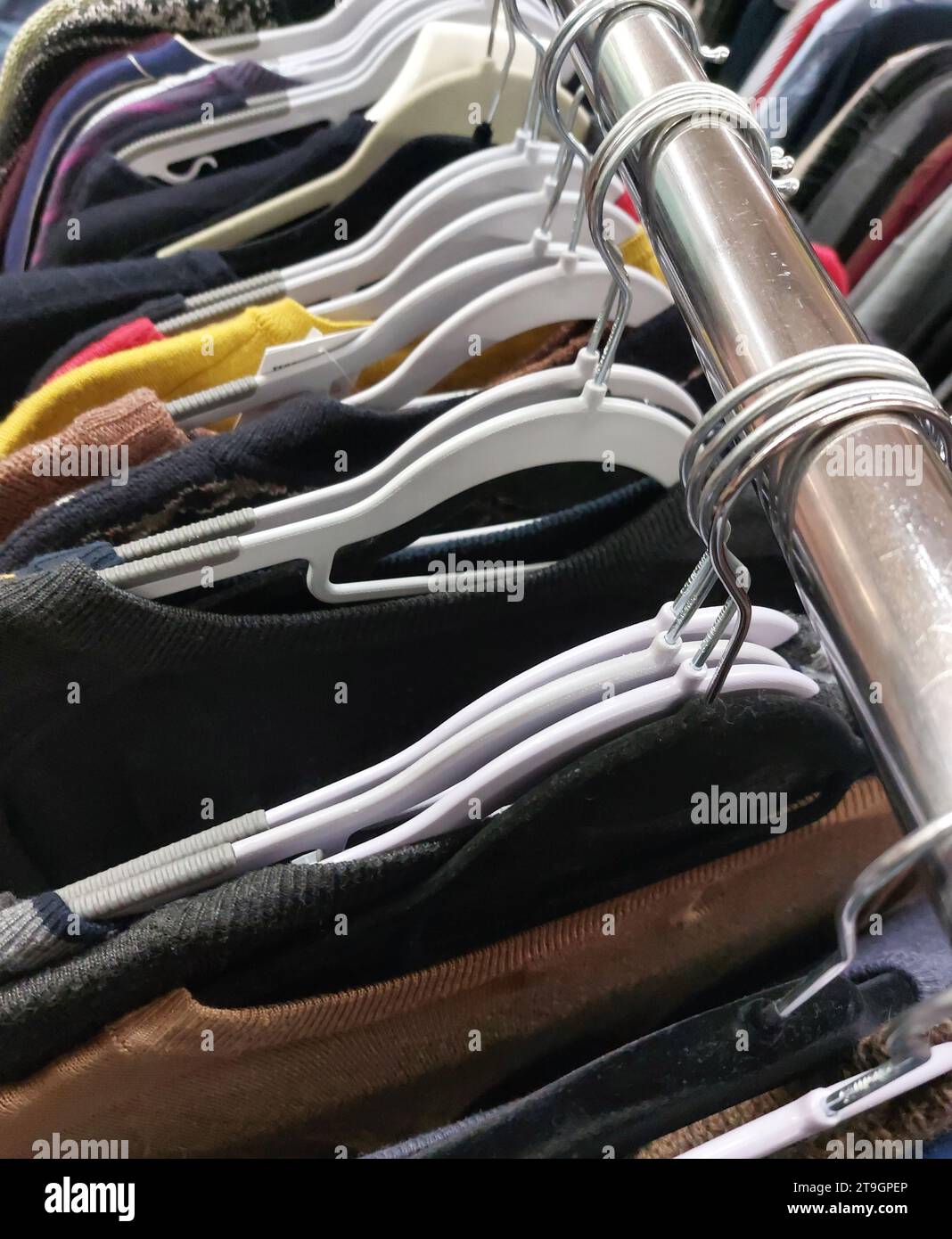 many clothes hanging on hangers in used clothing store Stock Photo Alamy