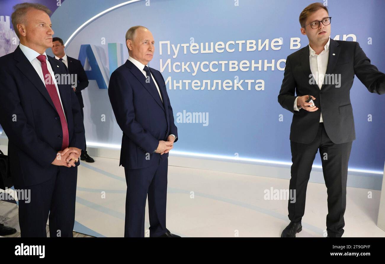 Moscow, Russia. 24th Nov, 2023. Russian President Vladimir Putin, center, with Sberbank CEO German Gref, left, tour an exhibition on the development of Artificial Intelligence at the Artificial Intelligence Journey 2023 conference, November 24, 2023 in Moscow, Russia. Credit: Mikhail Klimentyev/Kremlin Pool/Alamy Live News Stock Photo