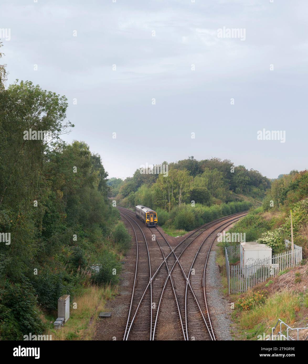 Northern Rail class 158 diesel multiple unit train passing Whitwood Junction, Castleford, Yorkshire with a diamond crossing in the foreground Stock Photo