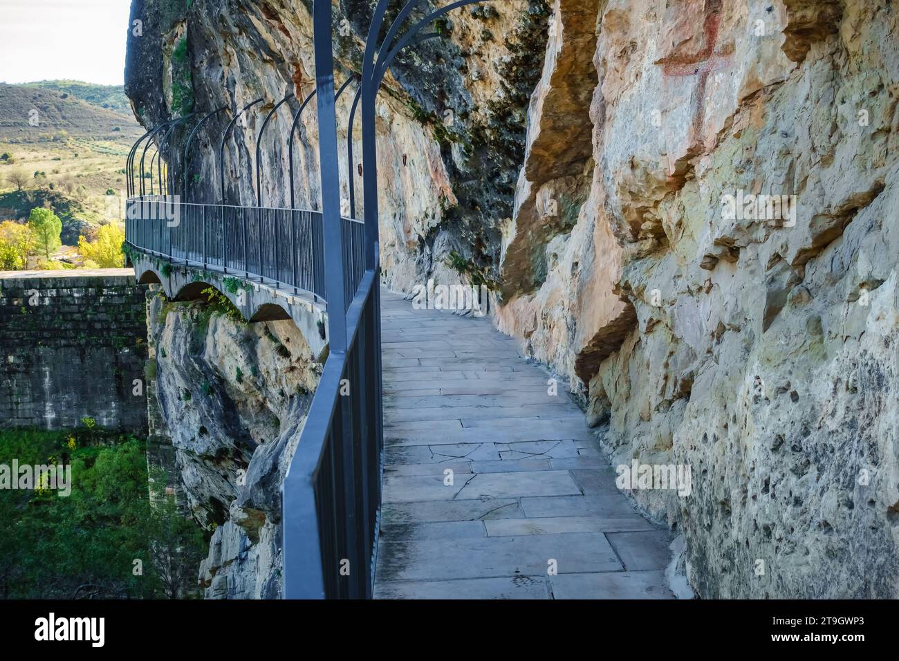 Path that runs hanging from the vertical rock wall at the Ponton de la Oliva, Madrid. Stock Photo