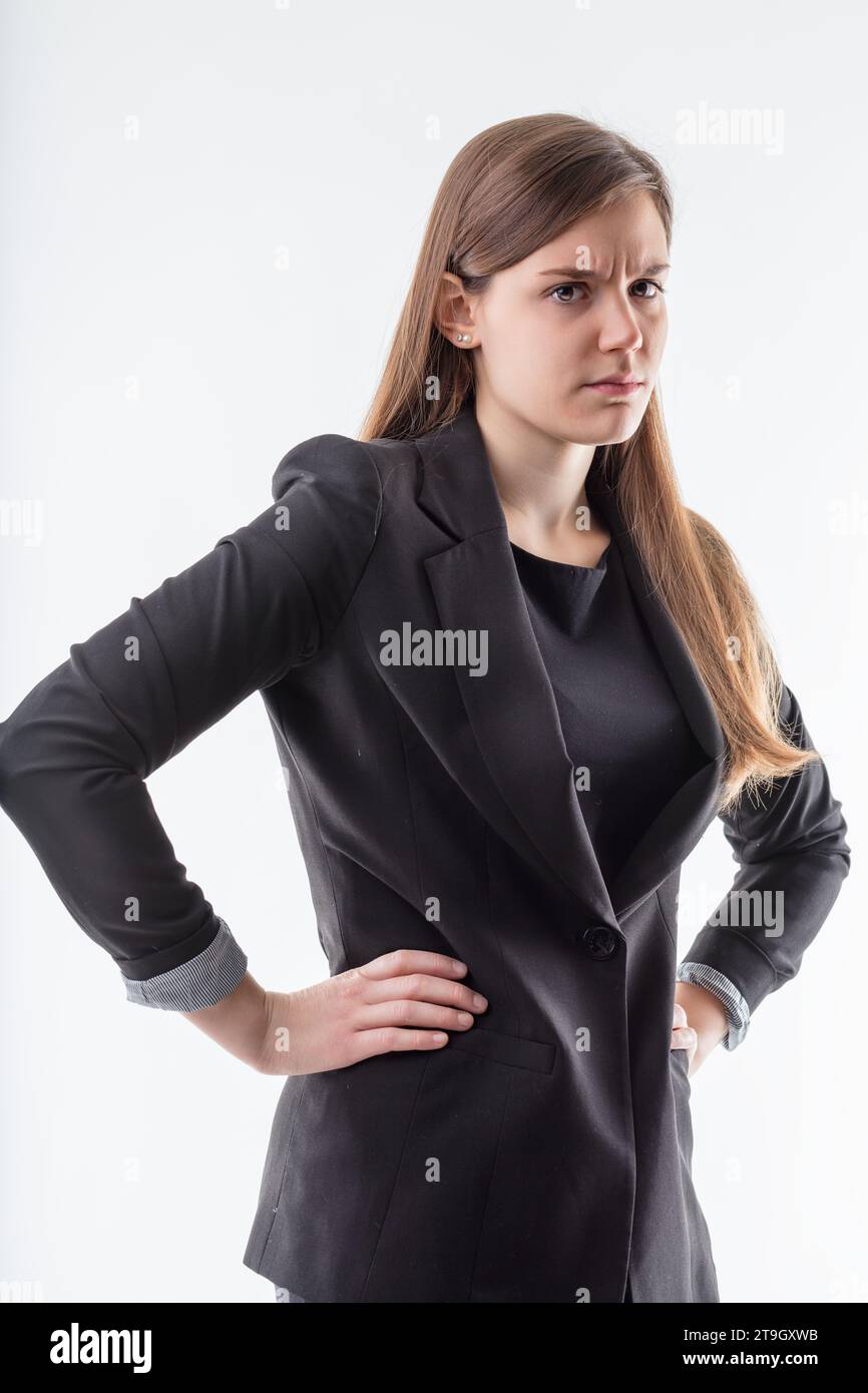 Resolute and steadfast, her expression and posture signal an uncompromising approach to business Stock Photo