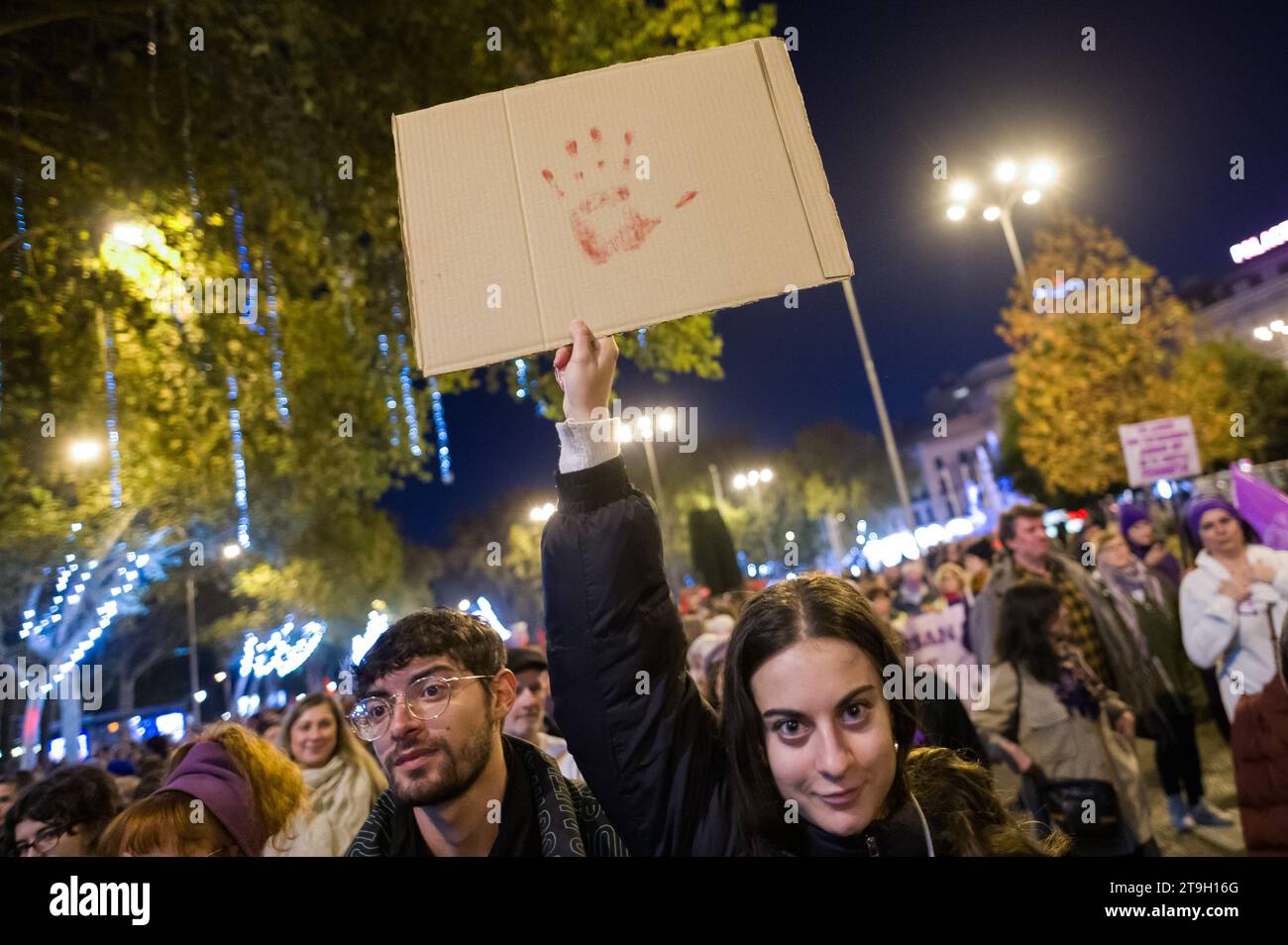 Madrid, Spain. 25th Nov, 2023. A woman carrying a placard with a fake