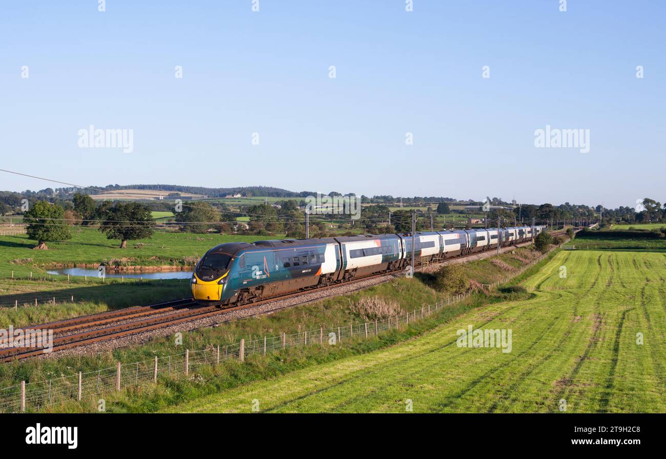 Avanti west coast class 390 Pendolino train passing the countryside at Plumpton (north of Penrith) on the west coast mainline in Cumbria Stock Photo