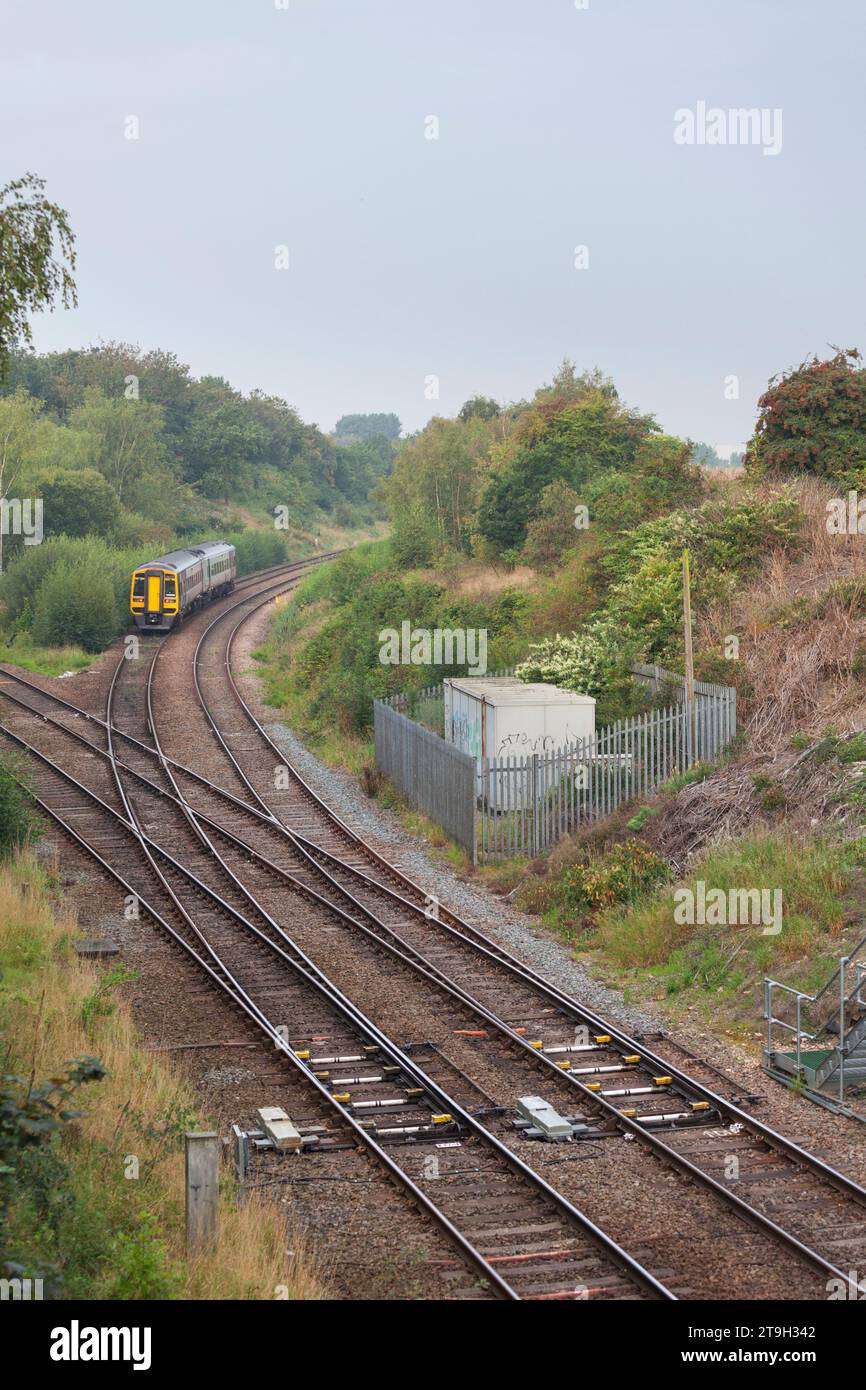 Northern Rail class 158 diesel multiple unit train passing Whitwood Junction, Castleford, Yorkshire with a diamond crossing in the foreground Stock Photo