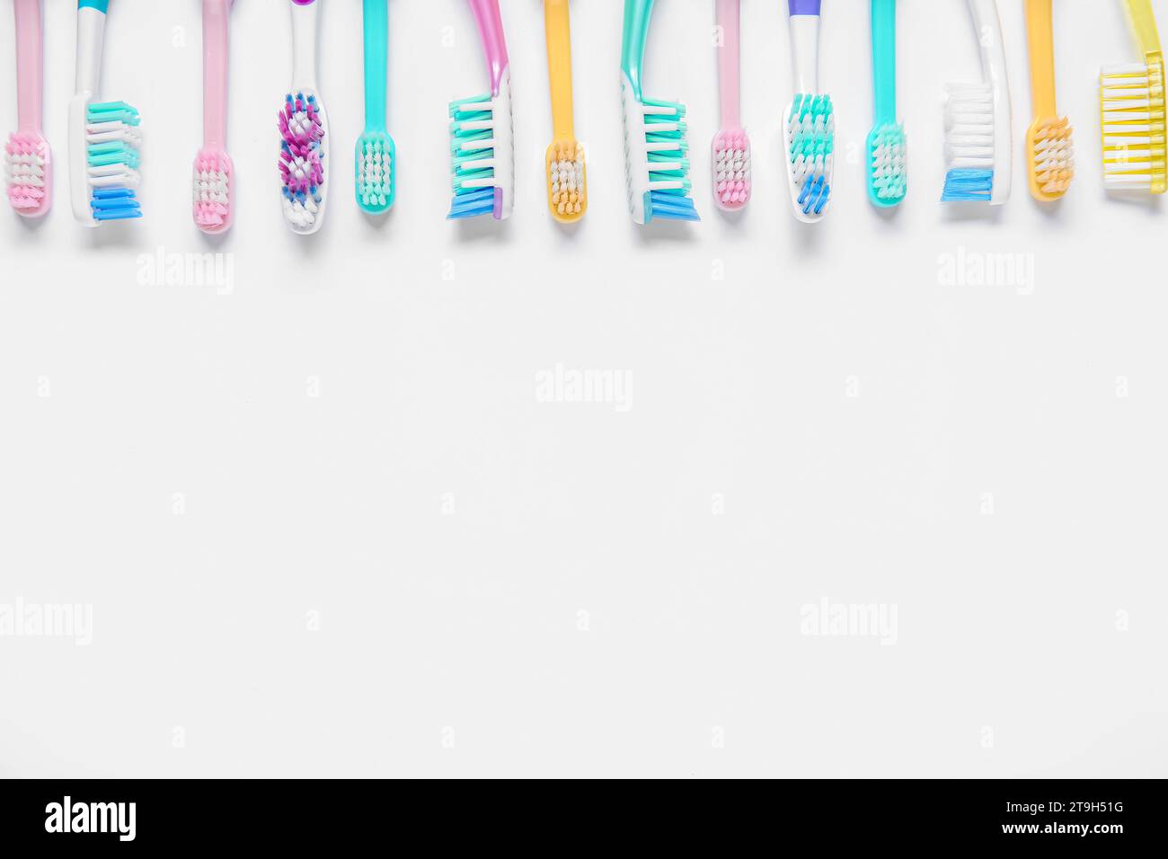 Colorful plastic toothbrushes on white background Stock Photo - Alamy