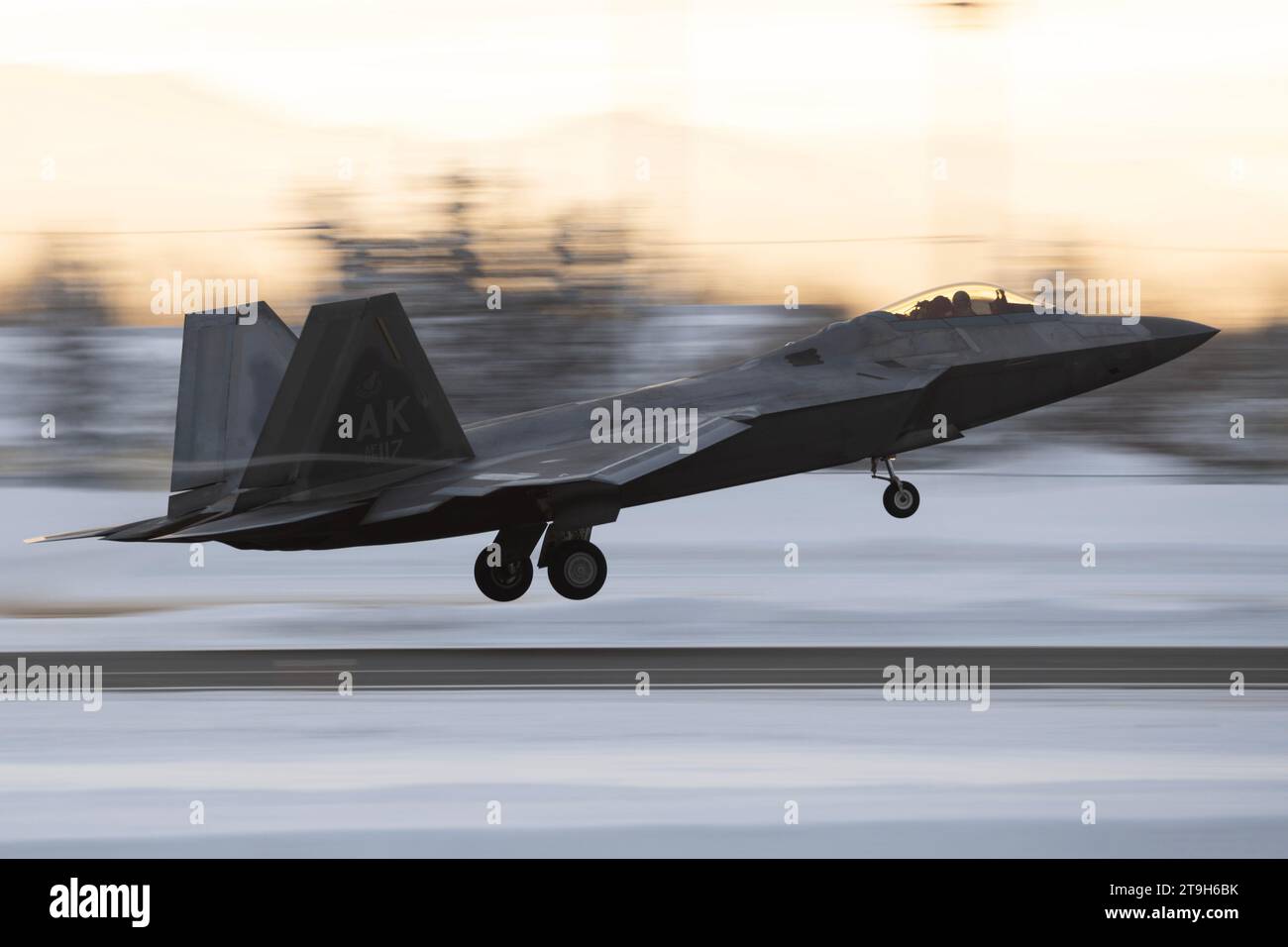 Anchorage, United States. 21 November, 2023. A U.S. Air Force F-22 Raptor fighter aircraft assigned to the 3rd Wing conducts flight operations off a snow cover field at Joint Base Elmendorf-Richardson, November 21, 2023 in Anchorage, Alaska.  Credit: Alejandro Pena/Planetpix/Alamy Live News Stock Photo