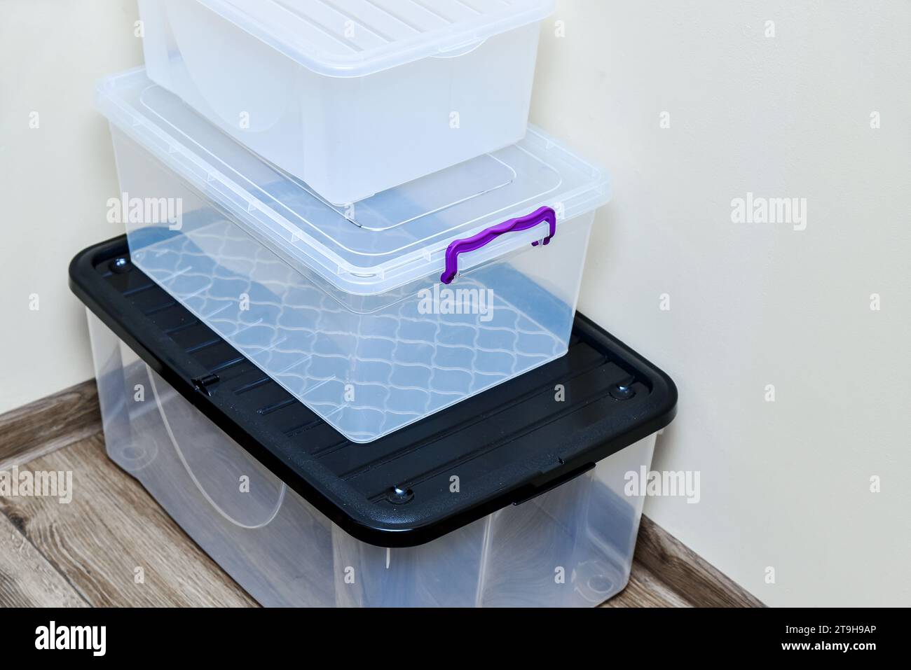 Empty plastic storage boxes in stack. Boxes with lids of different