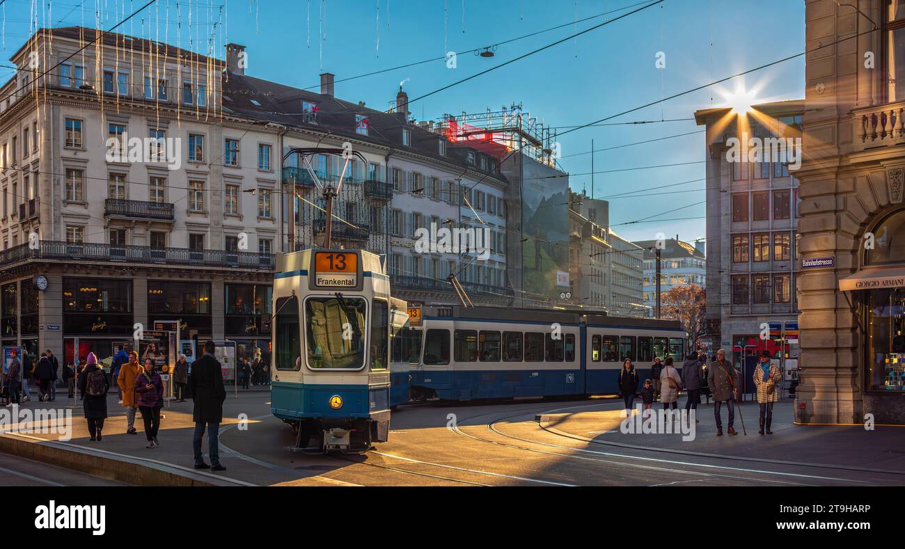 Zurich, Switzerland - November 11, 2023: Sun star above Paradeplatz square and a tram leaving the station Stock Photo