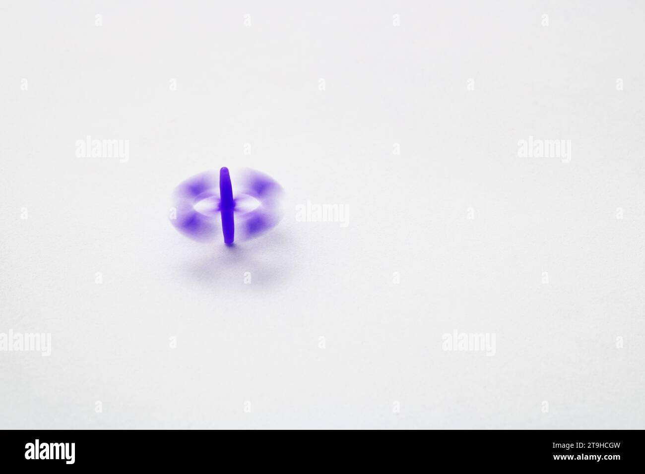 Purple rotating jack game piece Stock Photo Alamy