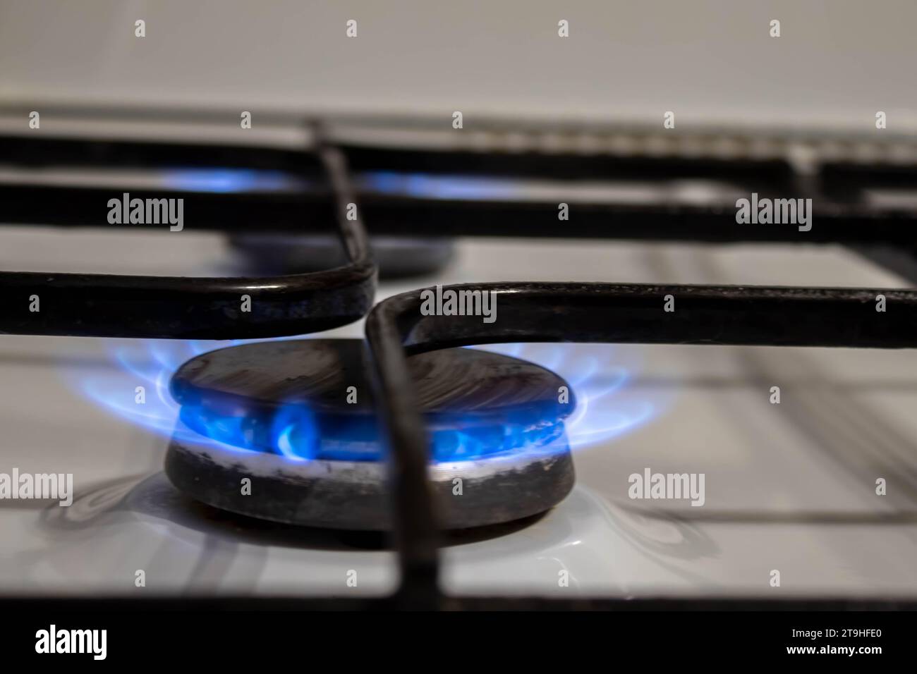 gas pipe with open yellow valve and burning gas burner, double exposure