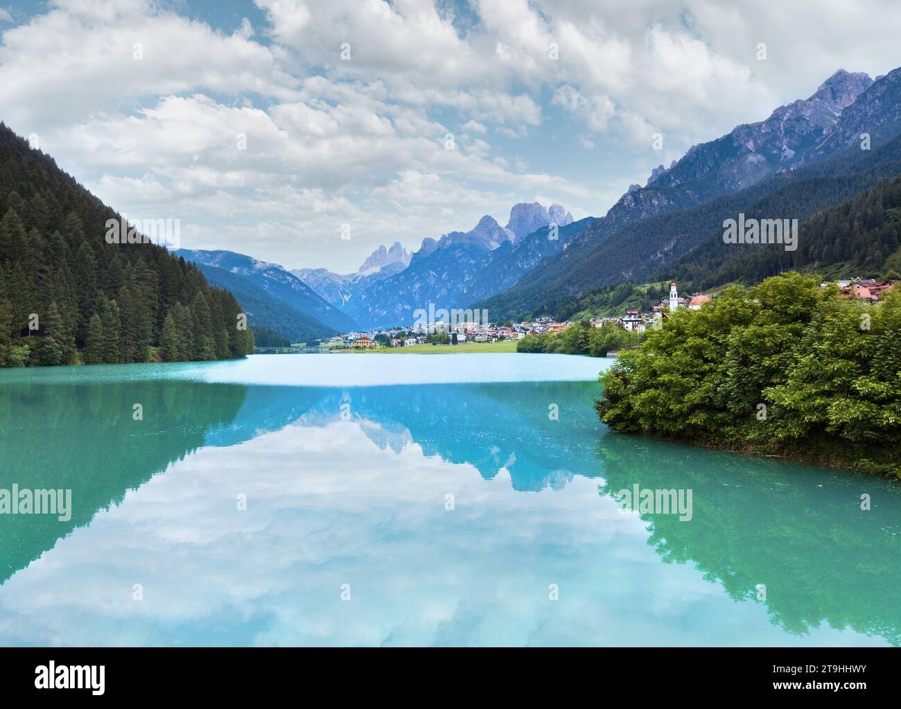 Tranquil summer Italian dolomites mountain lake and village view (Auronzo di Cadore) Stock Photo
