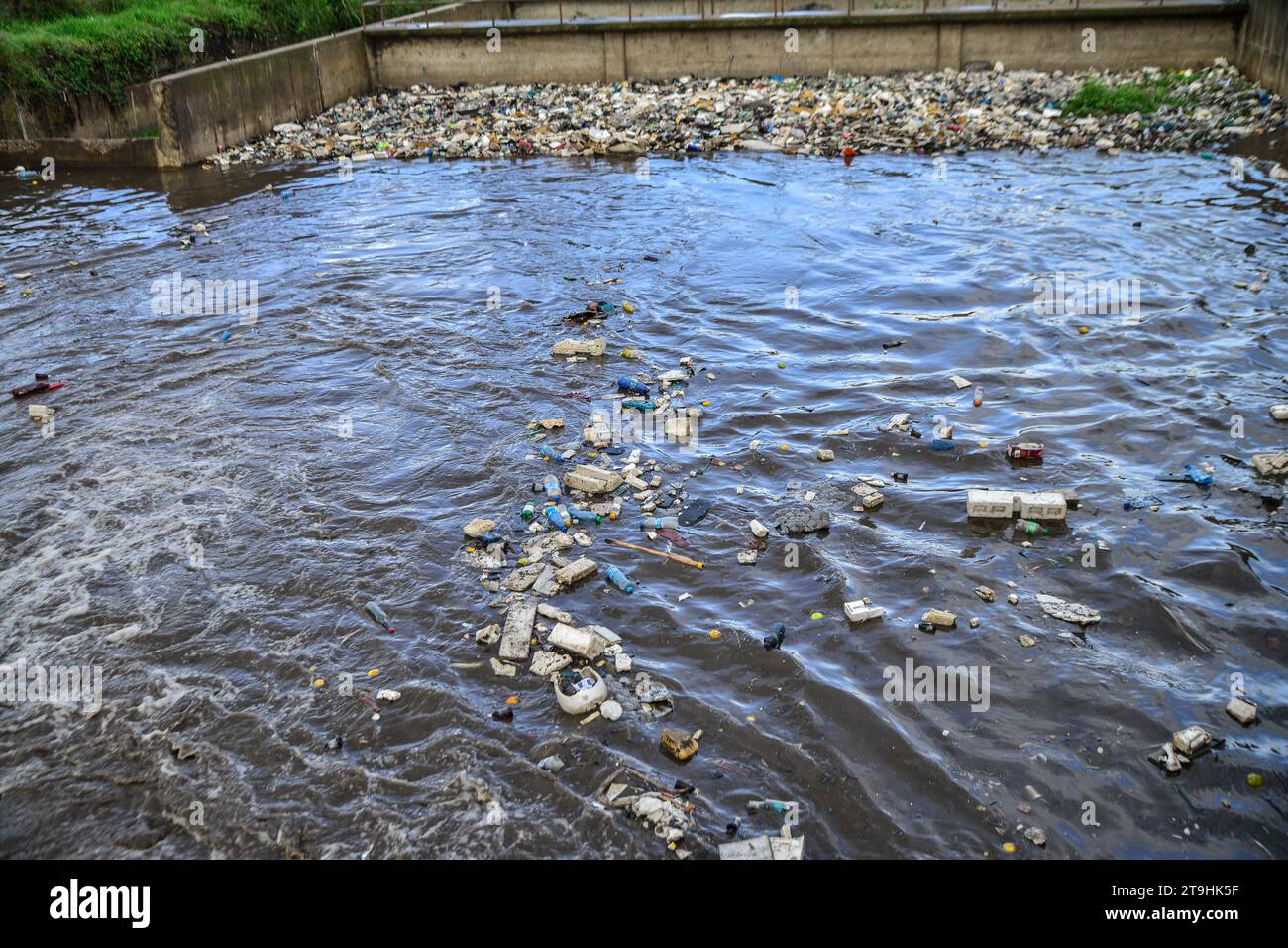 Nakuru, Kenya. 25th Nov, 2023. Plastic waste of all kind drifts on a storm water channel that