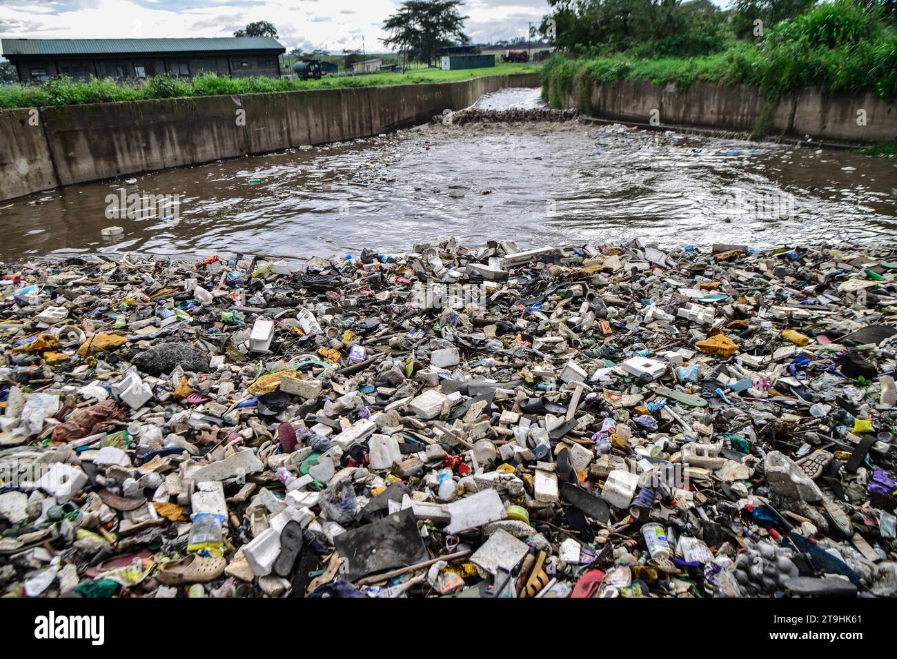 Nakuru, Kenya. 25th Nov, 2023. Plastic waste of all kind drifts on a storm water channel that