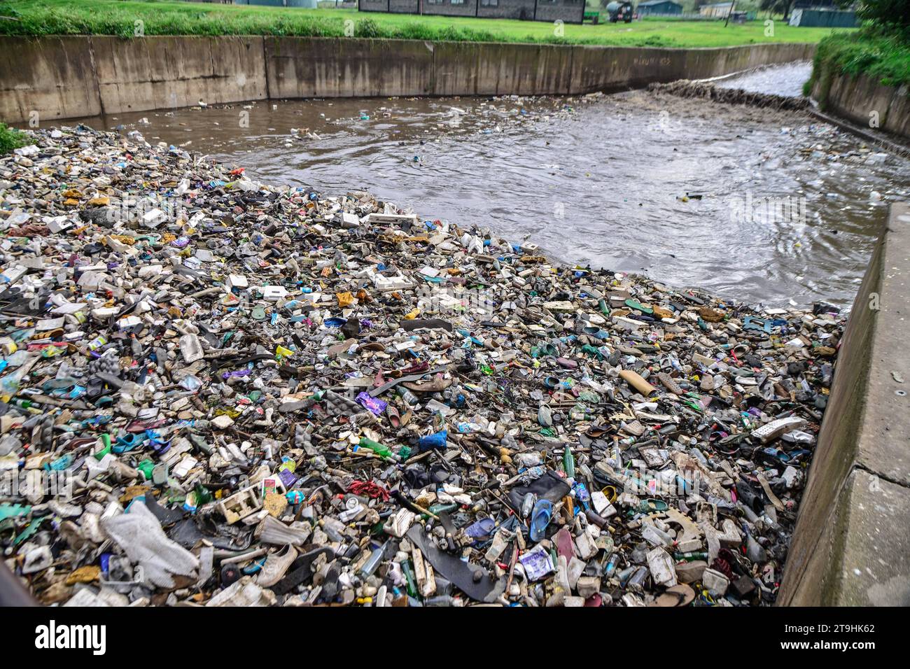 Nakuru, Kenya. 25th Nov, 2023. Plastic waste of all kind drifts on a storm water channel that
