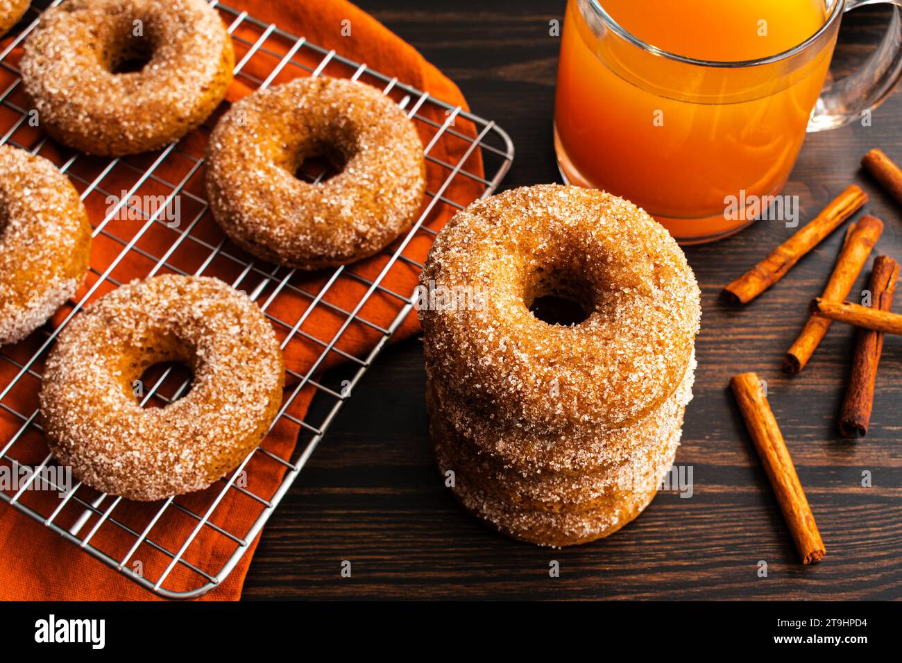 Baked Apple Cider Donuts with Cinnamon Sugar Coating: Baked doughnuts cooling on a wire rack viewed from directly above Stock Photo