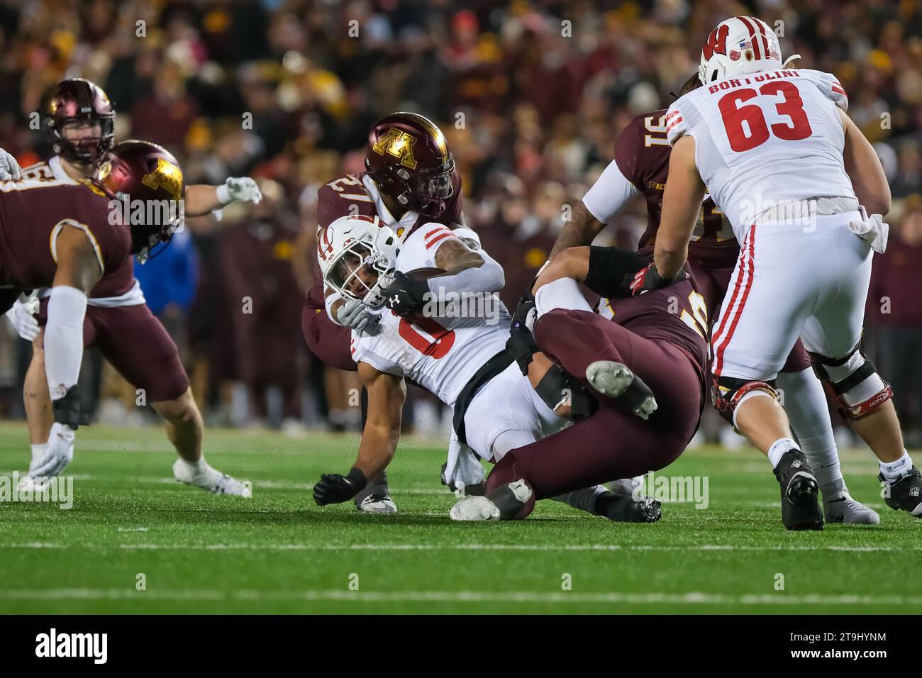 Minneapolis, Minnesota, USA. 25th Nov, 2023. Wisconsin Badgers running back BRAELON ALLEN #0 falls while being defended by Minnesota Golden Gophers defensive back TYLER NUBIN #27 during the second half of the Minnesota Golden Gophers versus the Wisconsin Badgers at Huntington Bank Stadium in Minneapolis, Minnesota on Saturday, November 25th 2023. (Credit Image: © Steven Garcia/ZUMA Press Wire) EDITORIAL USAGE ONLY! Not for Commercial USAGE! Stock Photo