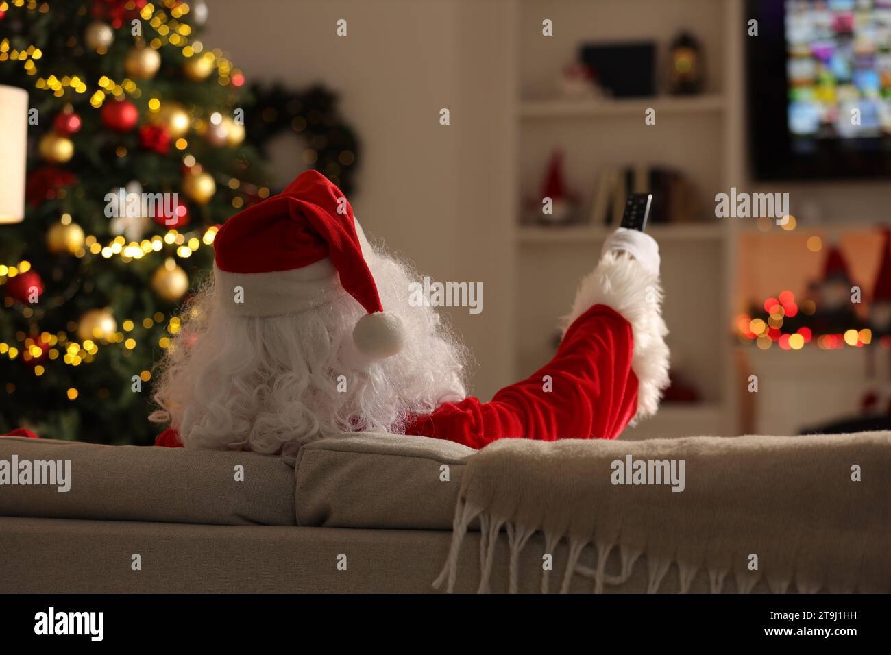 Santa Remote Control Merry Christmas. Santa Claus changing TV channels with remote control ...
