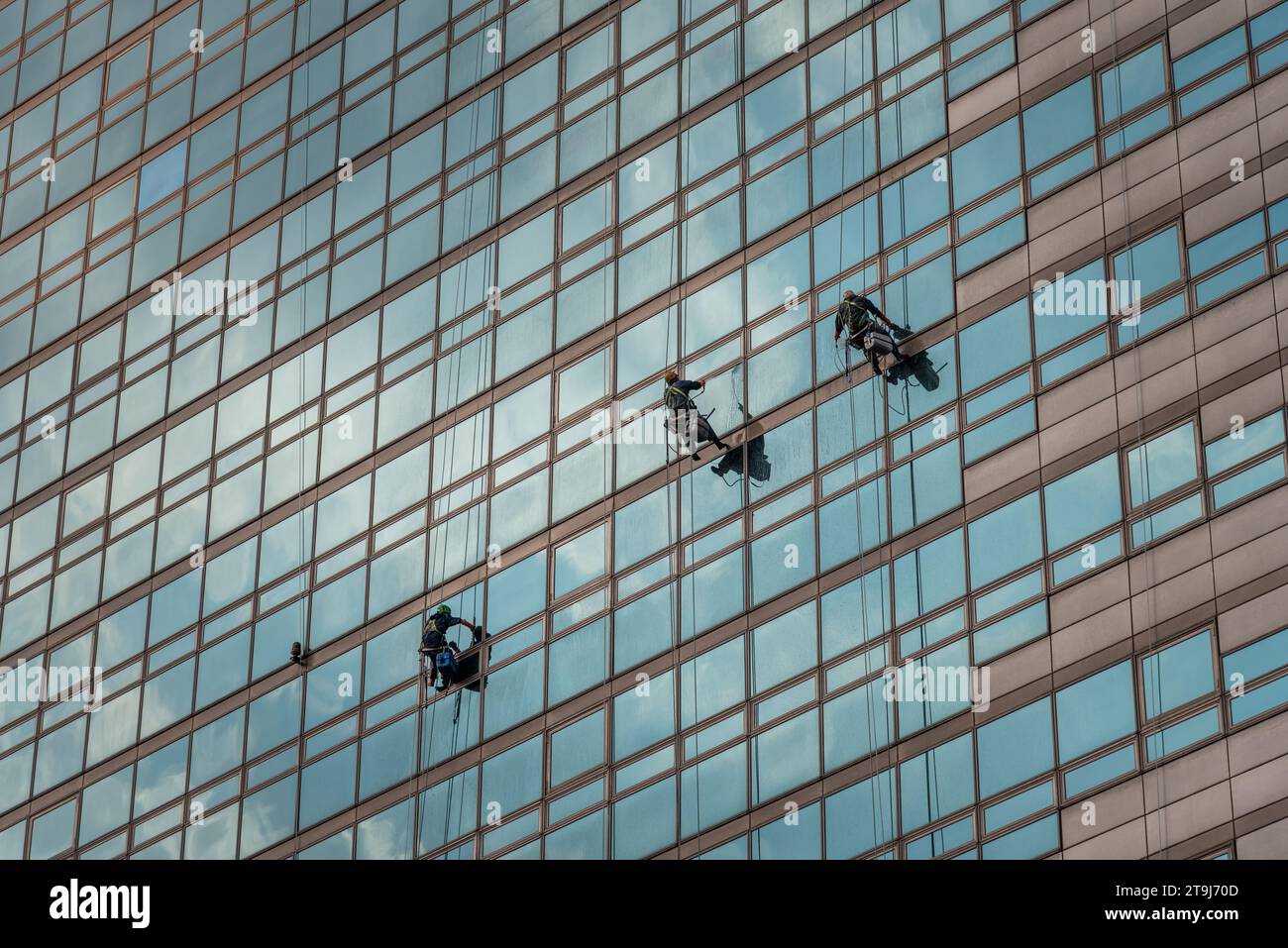 Workers cleaning windows of a skyscraper in Seoul, capital of South Korea Stock Photo