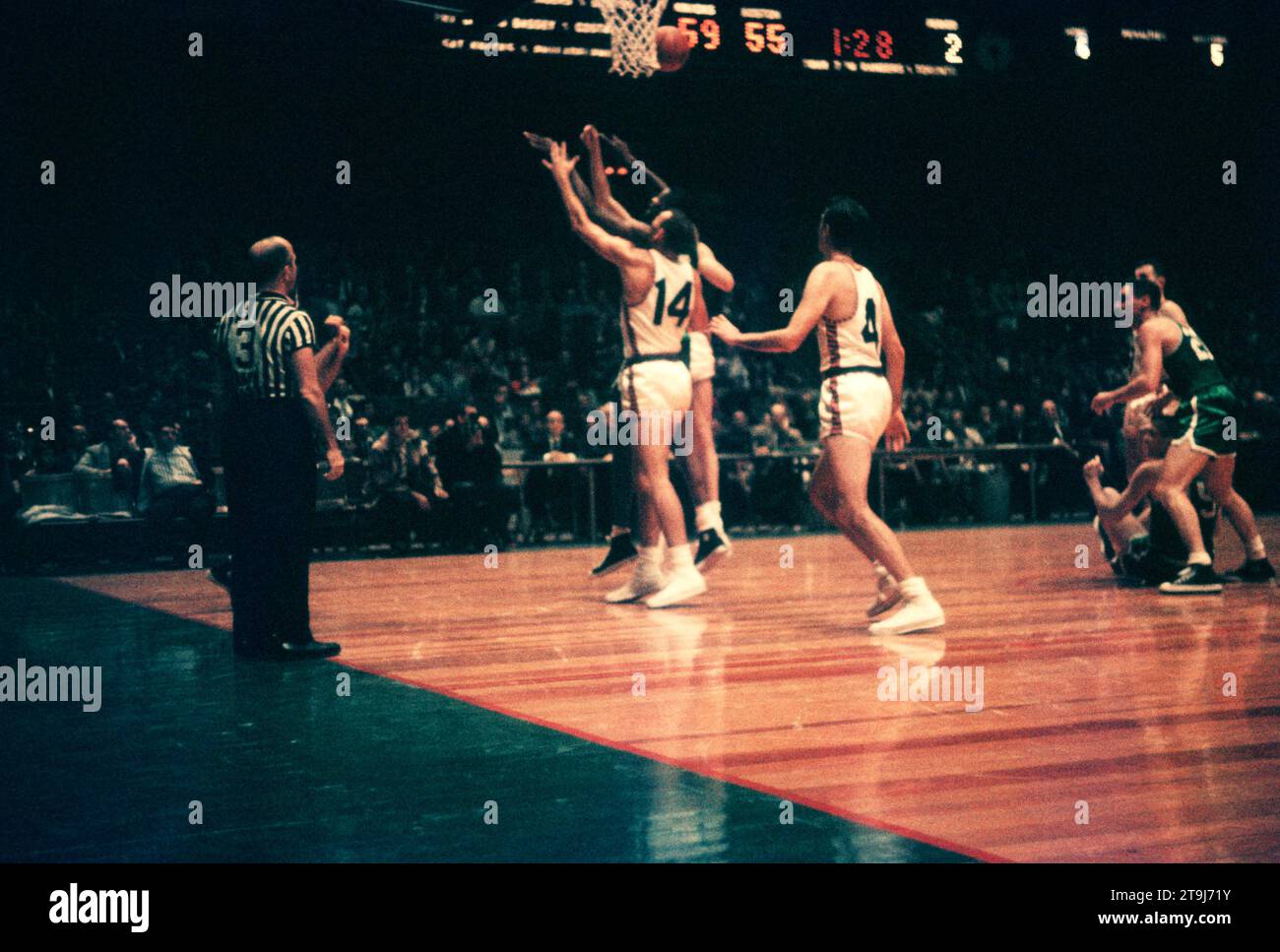 NEW YORK, NY - OCTOBER 25: Bill Russell #6 of the Boston Celtics grabs the rebound as Kenny Sears #12 and Charlie Tyra #14 of the New York Knicks defend during an NBA game on October 25, 1958 at the Madison Square Garden in New York, New York.  (Photo by Hy Peskin) *** Local Caption *** Bill Russell;Kenny Sears;Charlie Tyra Stock Photo