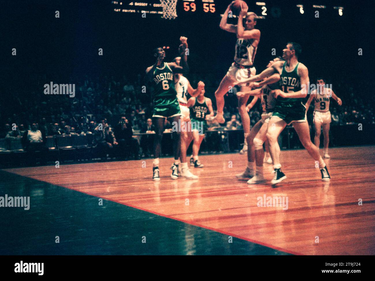 NEW YORK, NY - OCTOBER 25: Kenny Sears #12 of the New York Knicks grabs the rebound away from Bill Russell #6 and Tom Heinsohn #15 of the Boston Celtics during an NBA game on October 25, 1958 at the Madison Square Garden in New York, New York.  (Photo by Hy Peskin) *** Local Caption *** Kenny Sears;Bill Russell;Tom Heinsohn Stock Photo