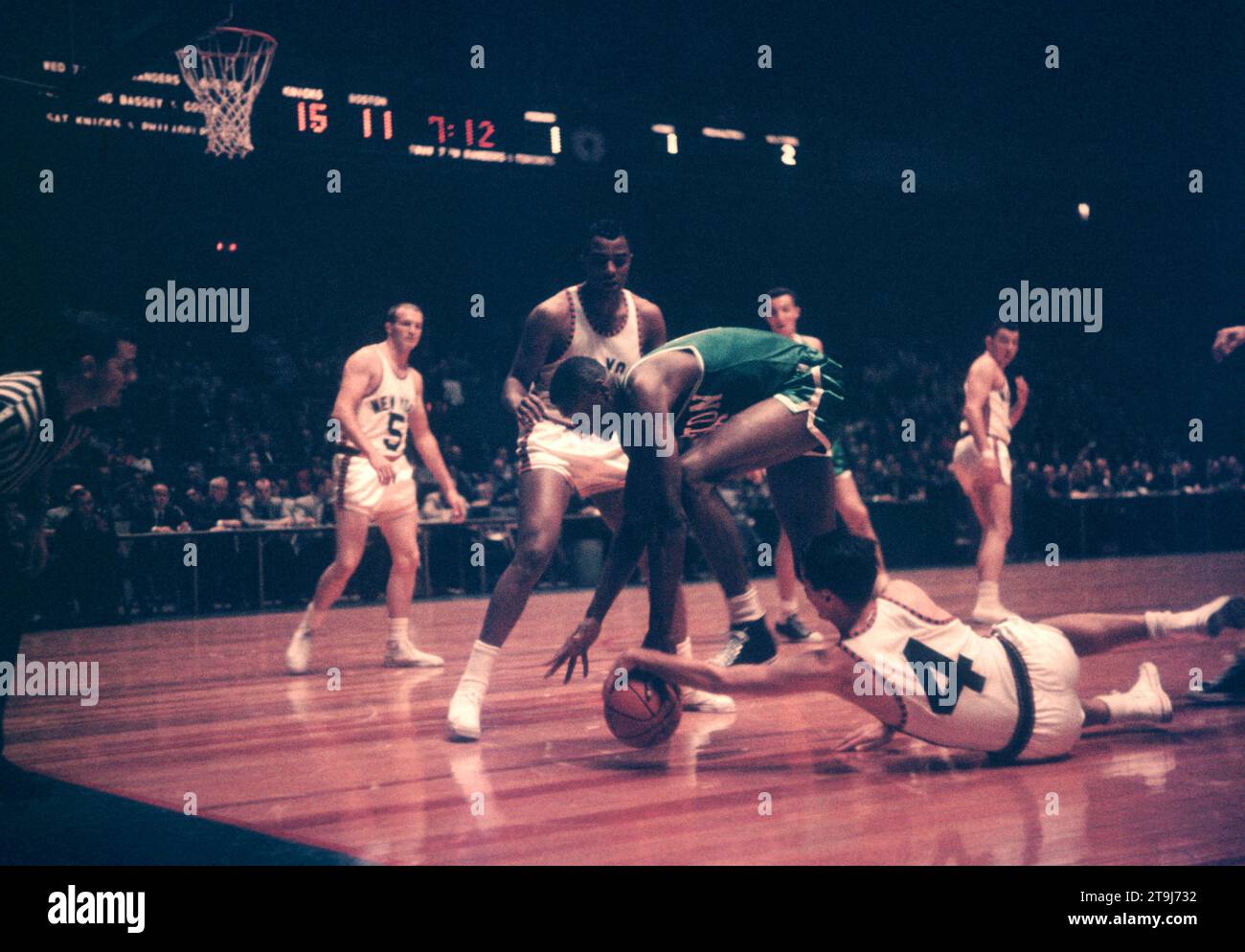 NEW YORK, NY - OCTOBER 25: Bill Russell #6 of the Boston Celtics fights for the ball with Carl Braun #4 and Willie Naulls #6 of the New York Knicks during an NBA game on October 25, 1958 at the Madison Square Garden in New York, New York.  (Photo by Hy Peskin) *** Local Caption *** Bill Russell;Carl Braun;Willie Naulls Stock Photo