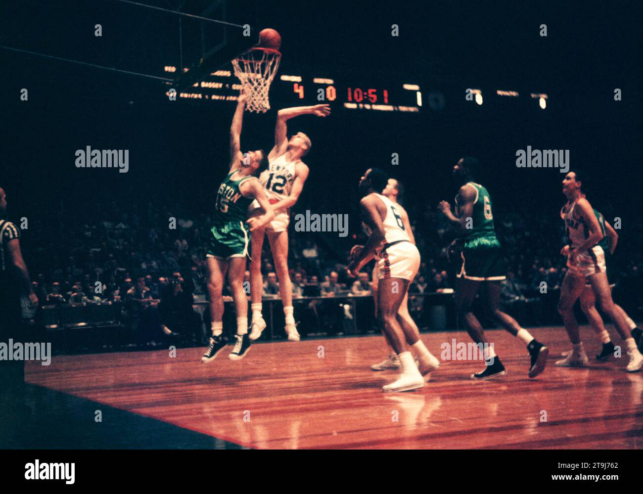 NEW YORK, NY - OCTOBER 25:  Tom Heinsohn #15 of the Boston Celtics shoots as Kenny Sears #12 of the New York Knicks goes for the block during an NBA game on October 25, 1958 at the Madison Square Garden in New York, New York.  (Photo by Hy Peskin) *** Local Caption *** Tom Heinsohn;Kenny Sears Stock Photo