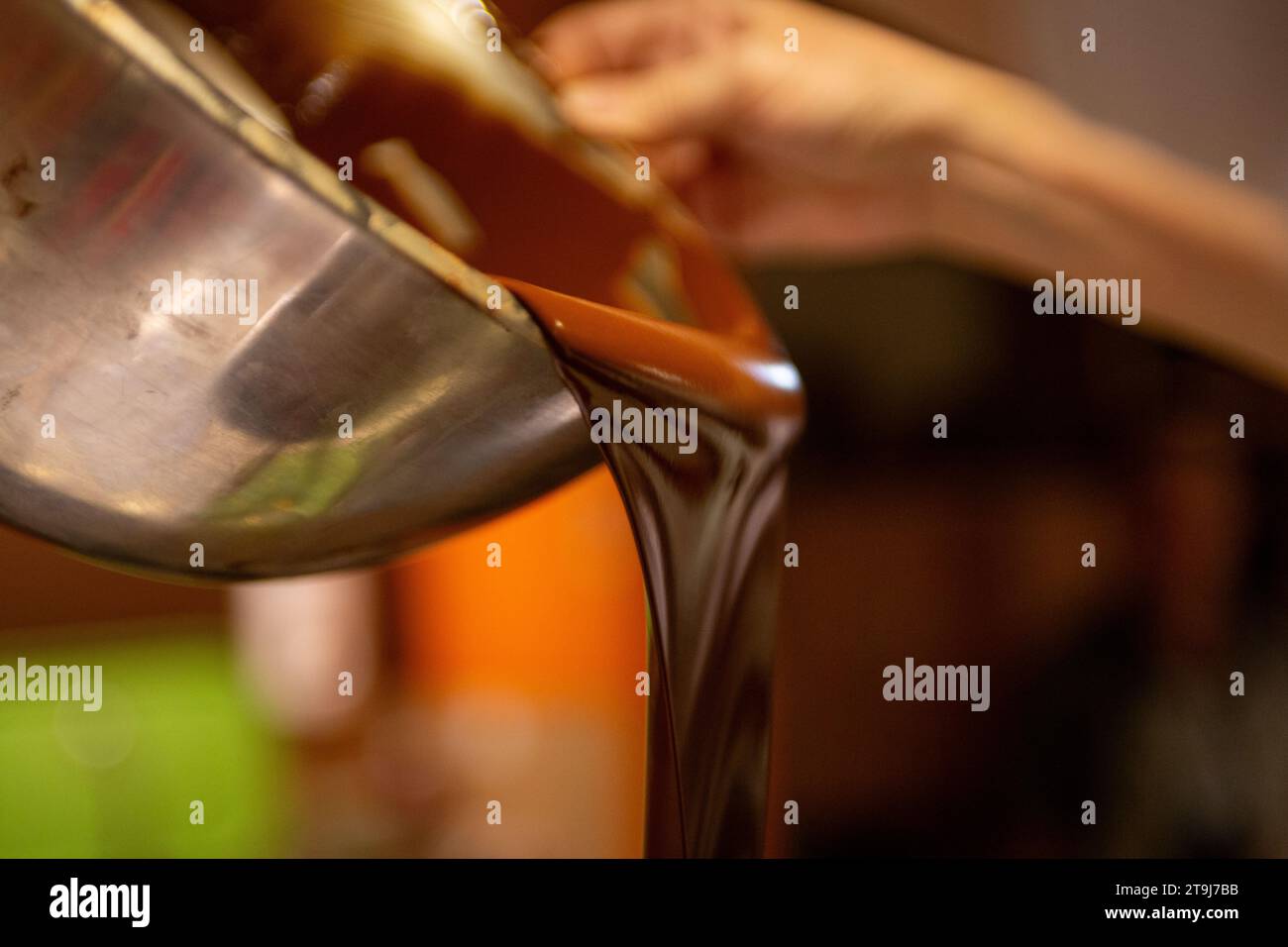 A Chocolatier Pouring Melted Chocolate Stock Photo